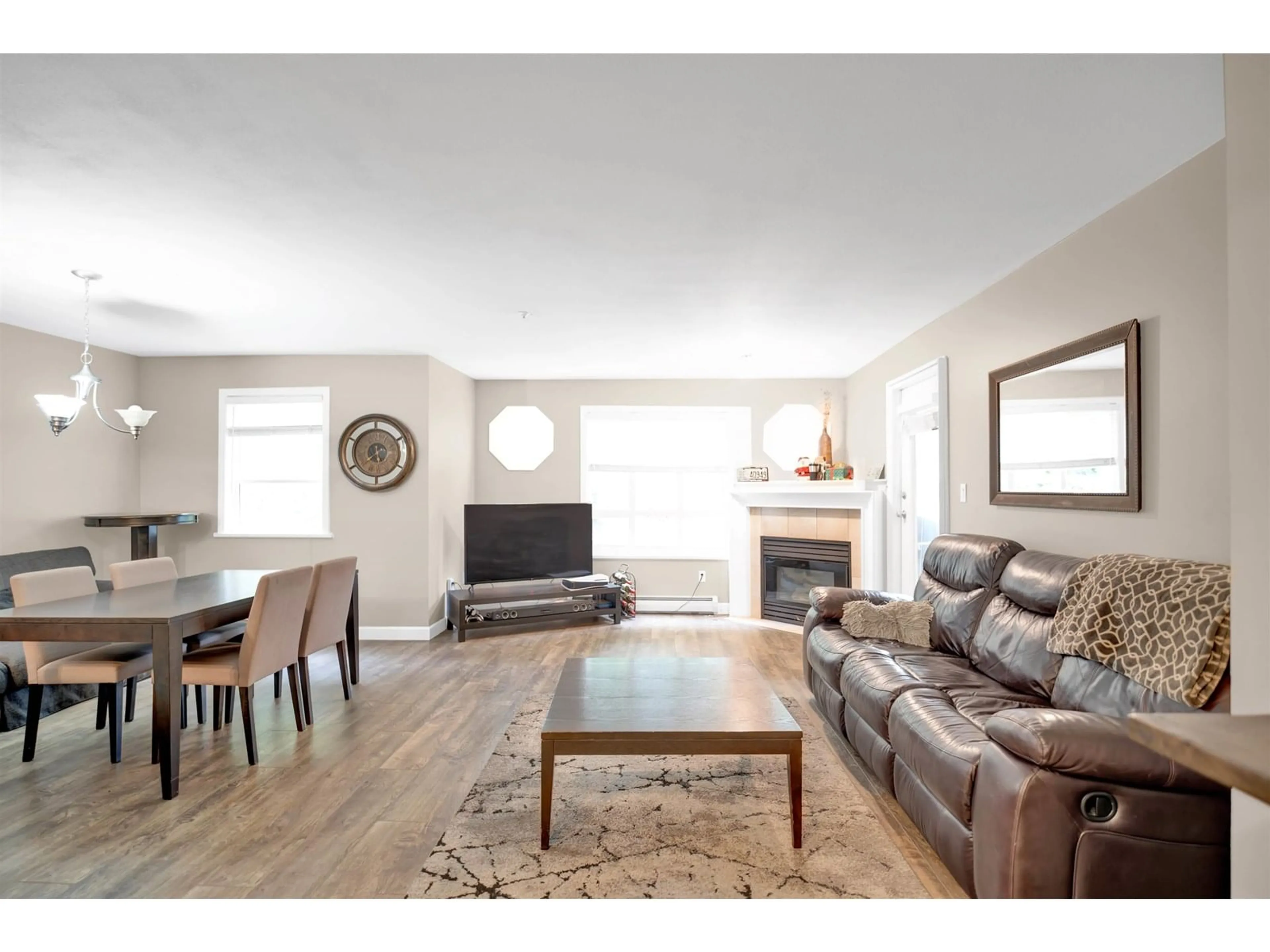 Living room with furniture, wood/laminate floor for 107 - 5909 177B, Surrey British Columbia V3S4J7