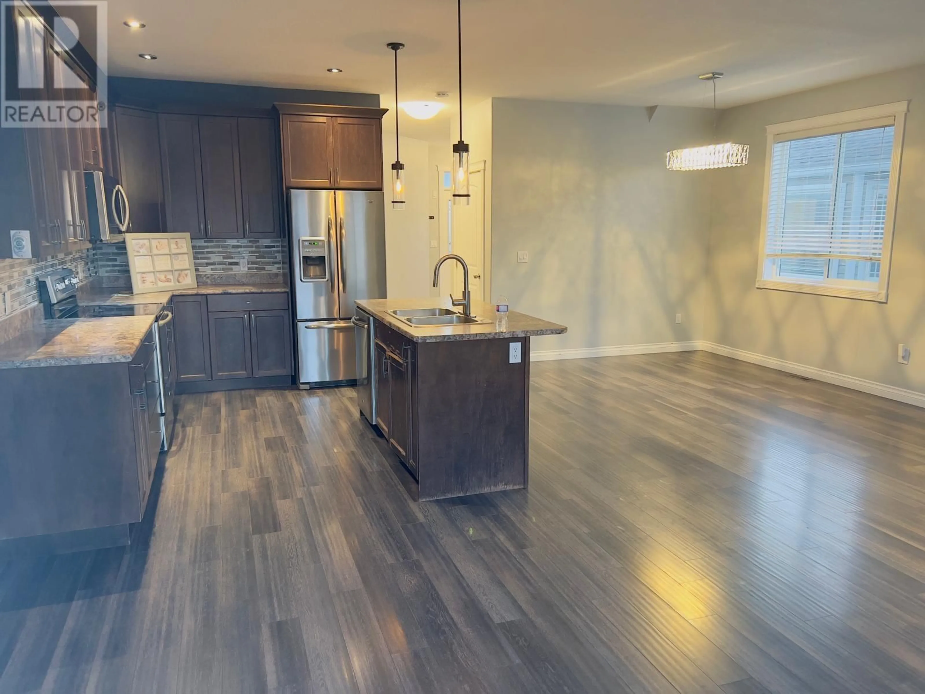 Open concept kitchen, wood/laminate floor for 11022 104A AVENUE, Fort St. John British Columbia V1J0J3