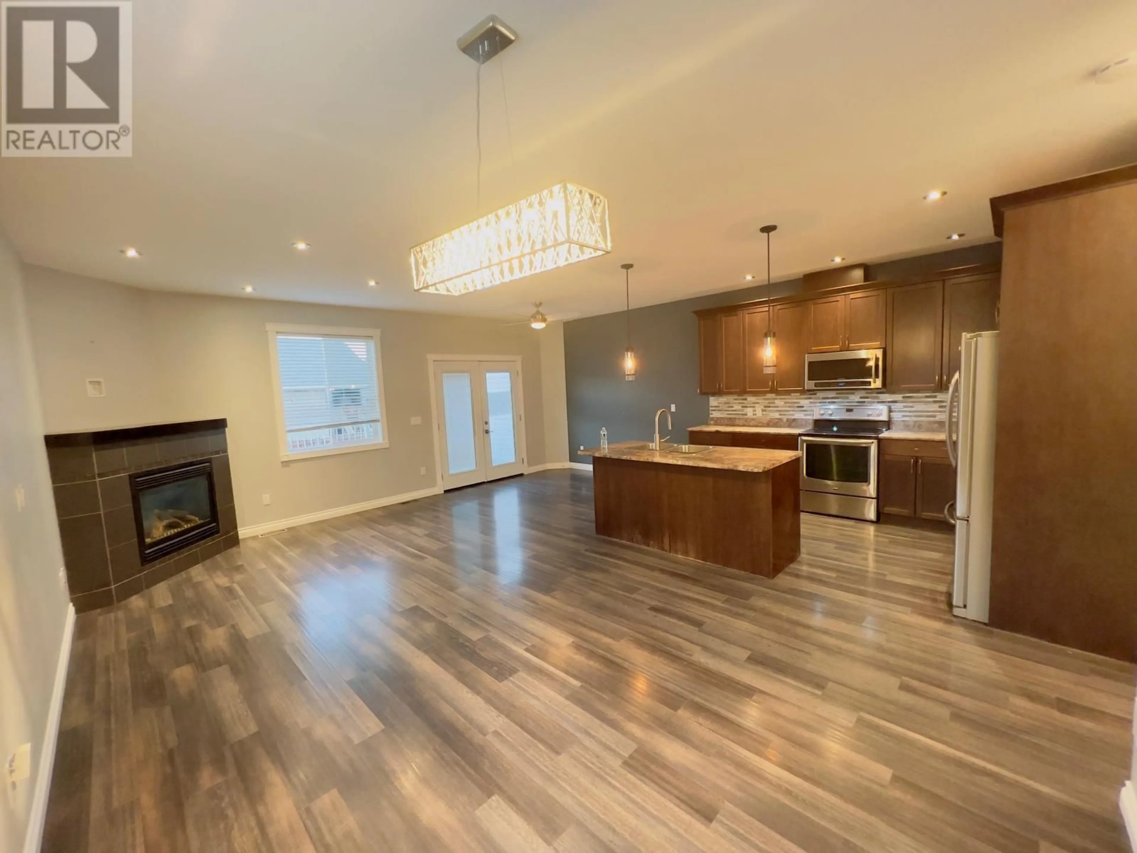 Open concept kitchen, wood/laminate floor for 11022 104A AVENUE, Fort St. John British Columbia V1J0J3