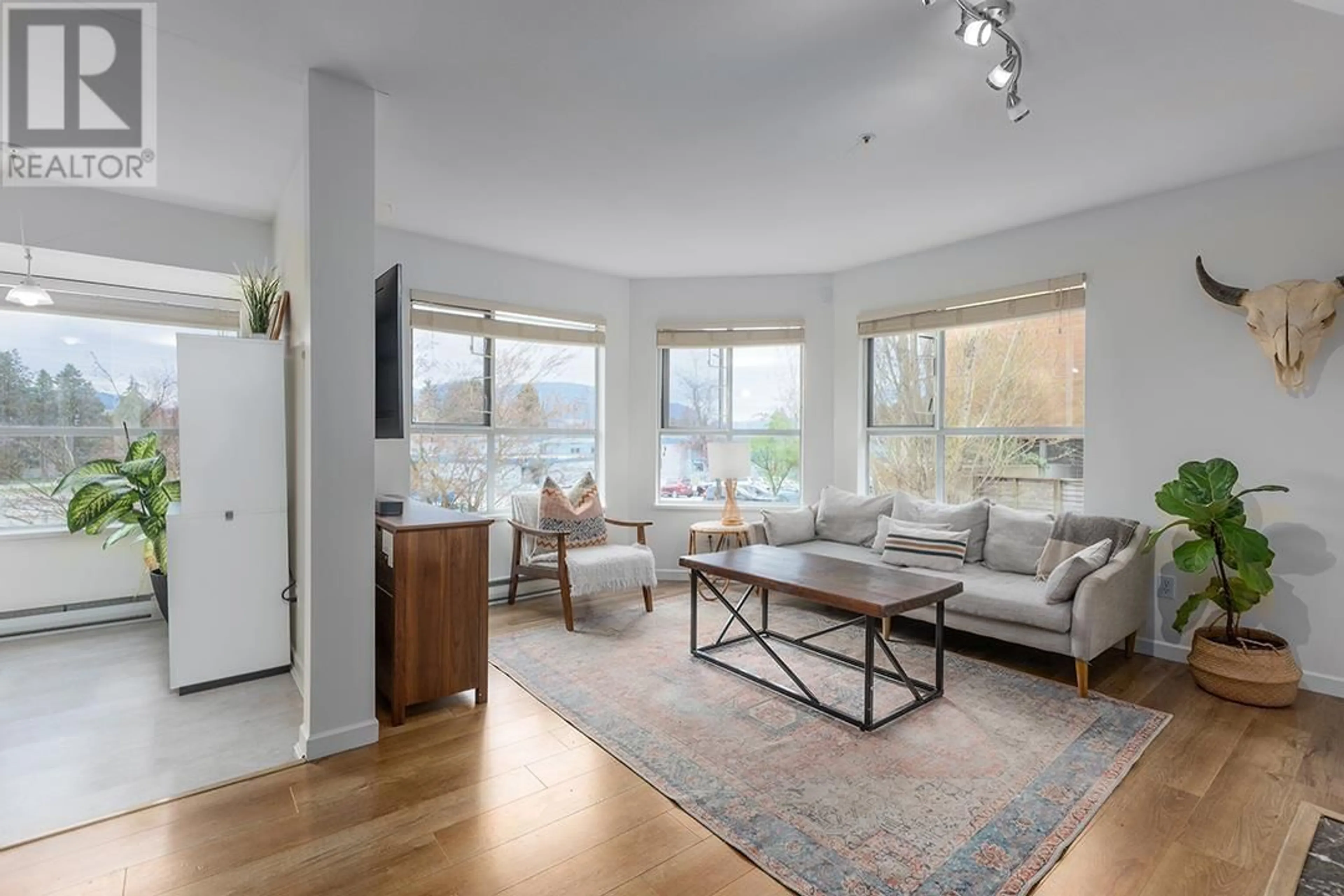 Living room with furniture, unknown for 208 - 2285 PITT RIVER ROAD, Port Coquitlam British Columbia V3C1R7