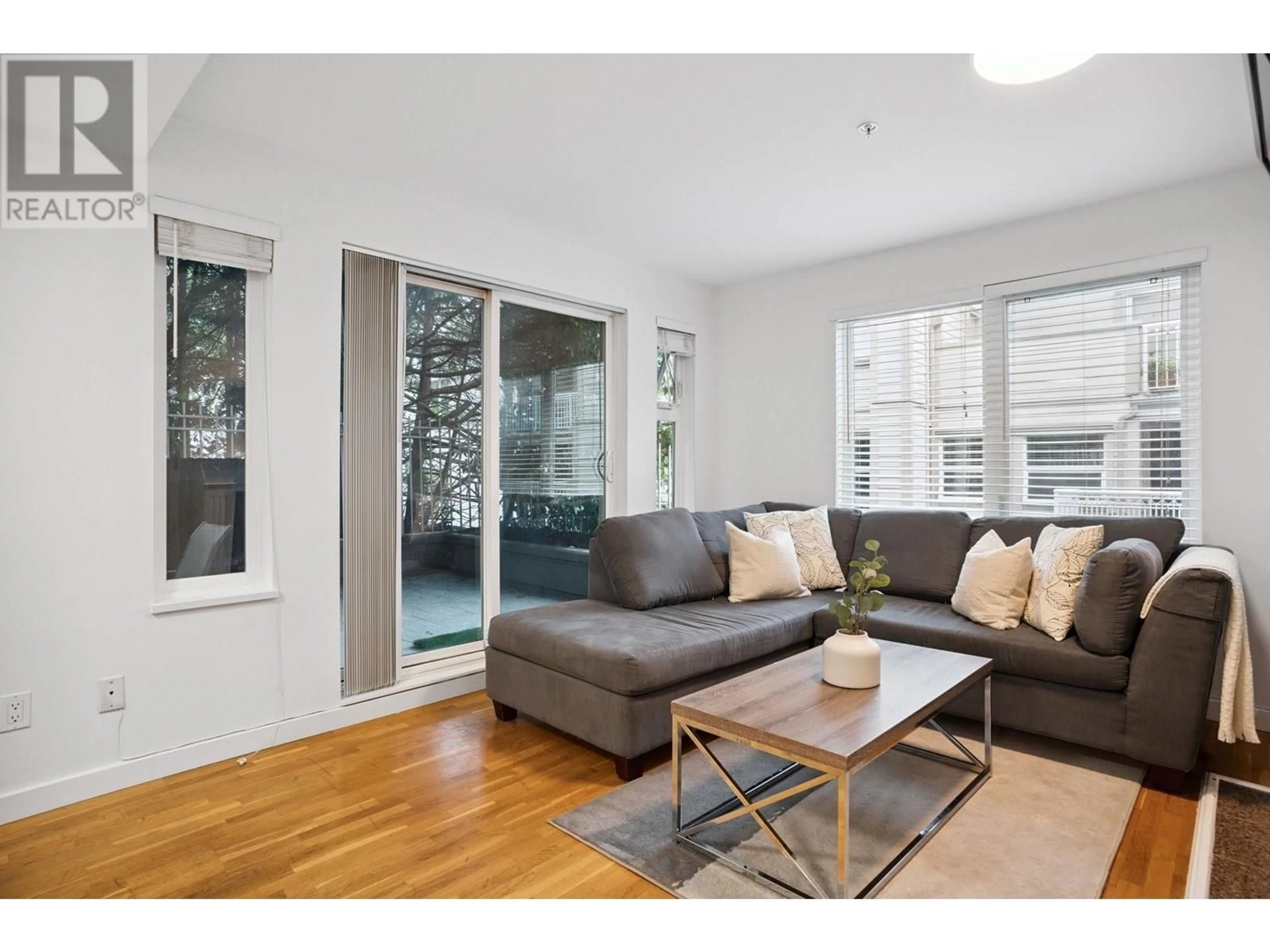 Living room with furniture, wood/laminate floor for 104 - 725 7 AVENUE, Vancouver British Columbia V5Z1B9