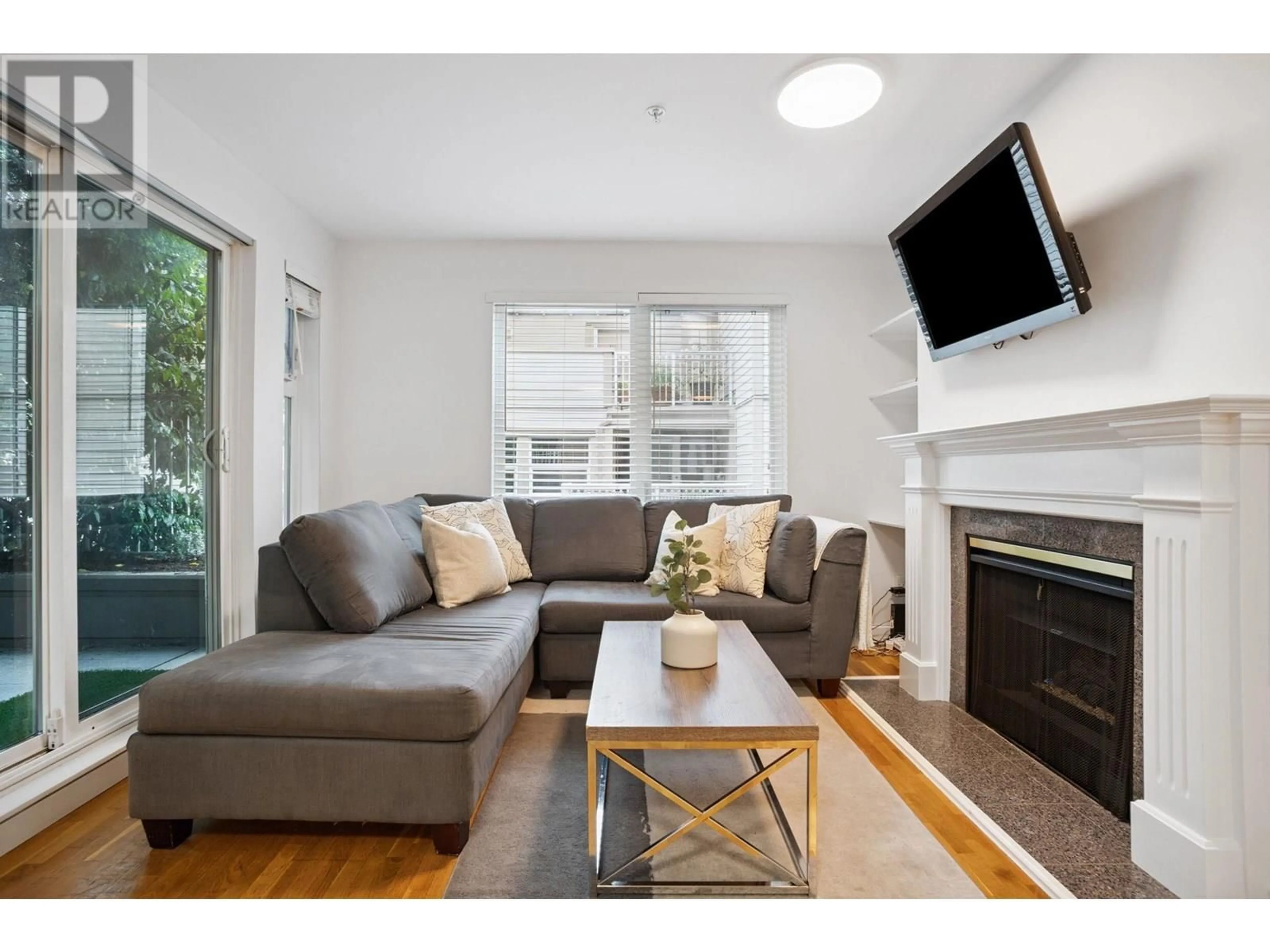 Living room with furniture, wood/laminate floor for 104 - 725 7 AVENUE, Vancouver British Columbia V5Z1B9