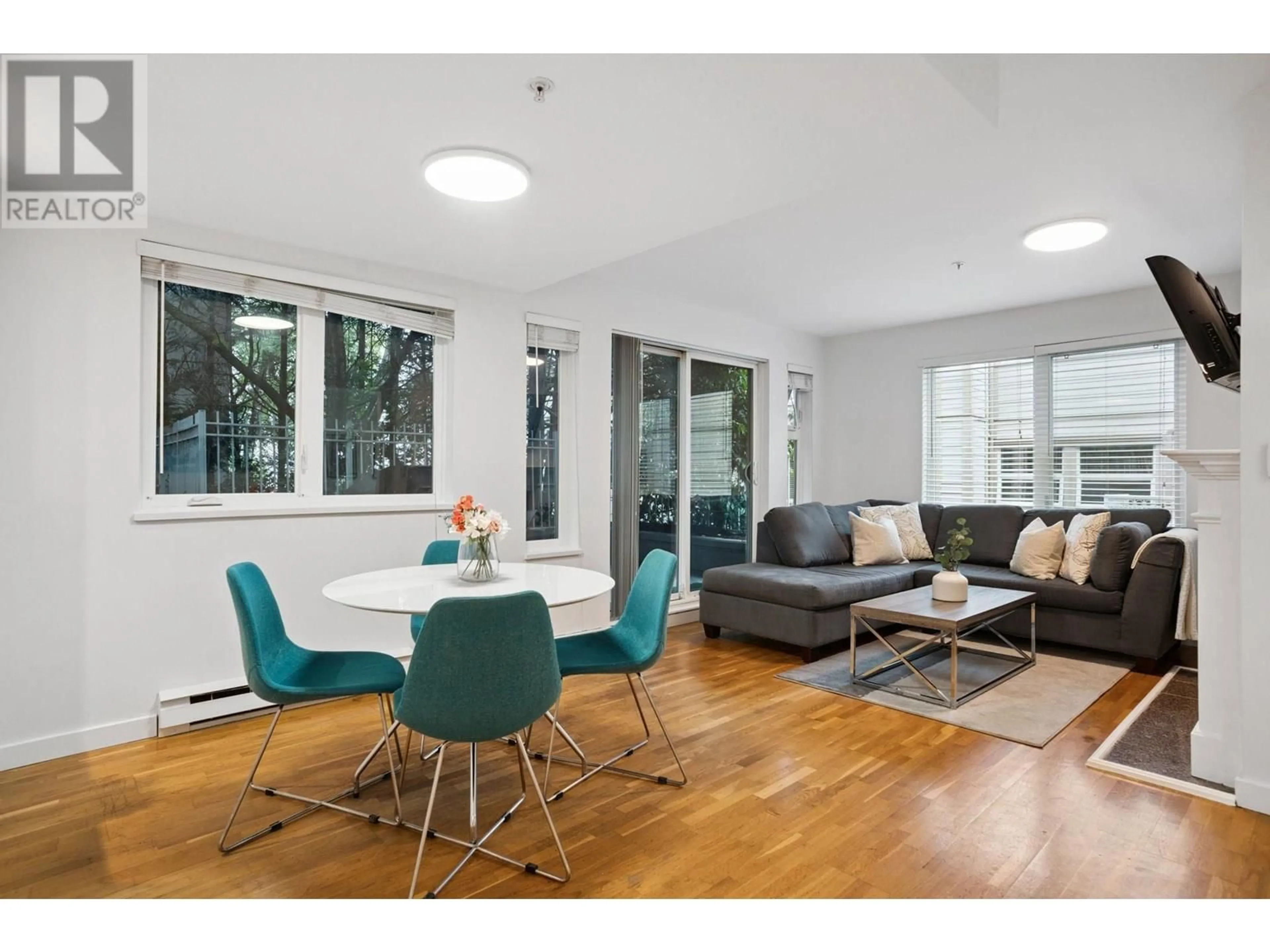 Living room with furniture, wood/laminate floor for 104 - 725 7 AVENUE, Vancouver British Columbia V5Z1B9