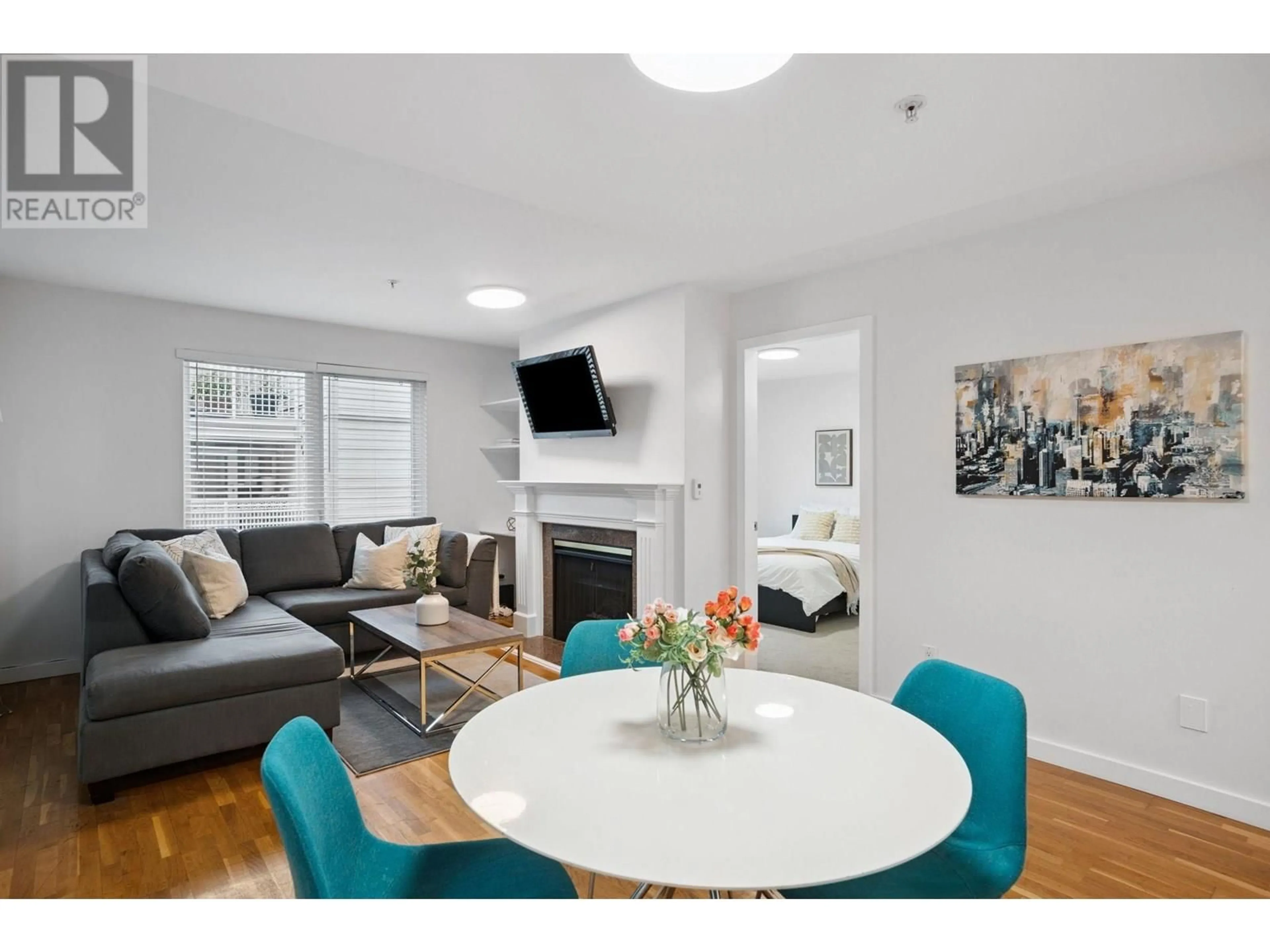 Living room with furniture, wood/laminate floor for 104 - 725 7 AVENUE, Vancouver British Columbia V5Z1B9