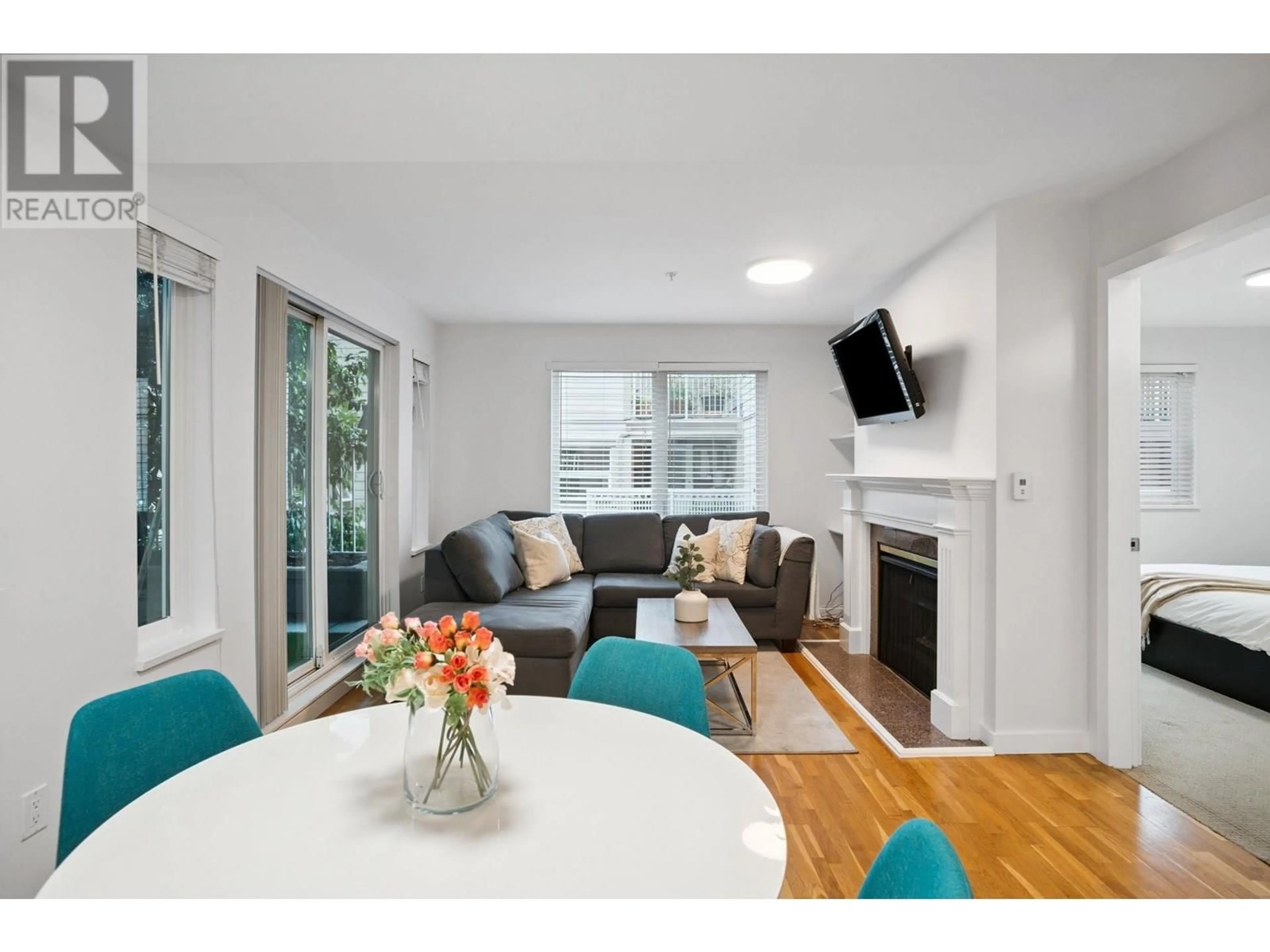 Living room with furniture, wood/laminate floor for 104 - 725 7 AVENUE, Vancouver British Columbia V5Z1B9