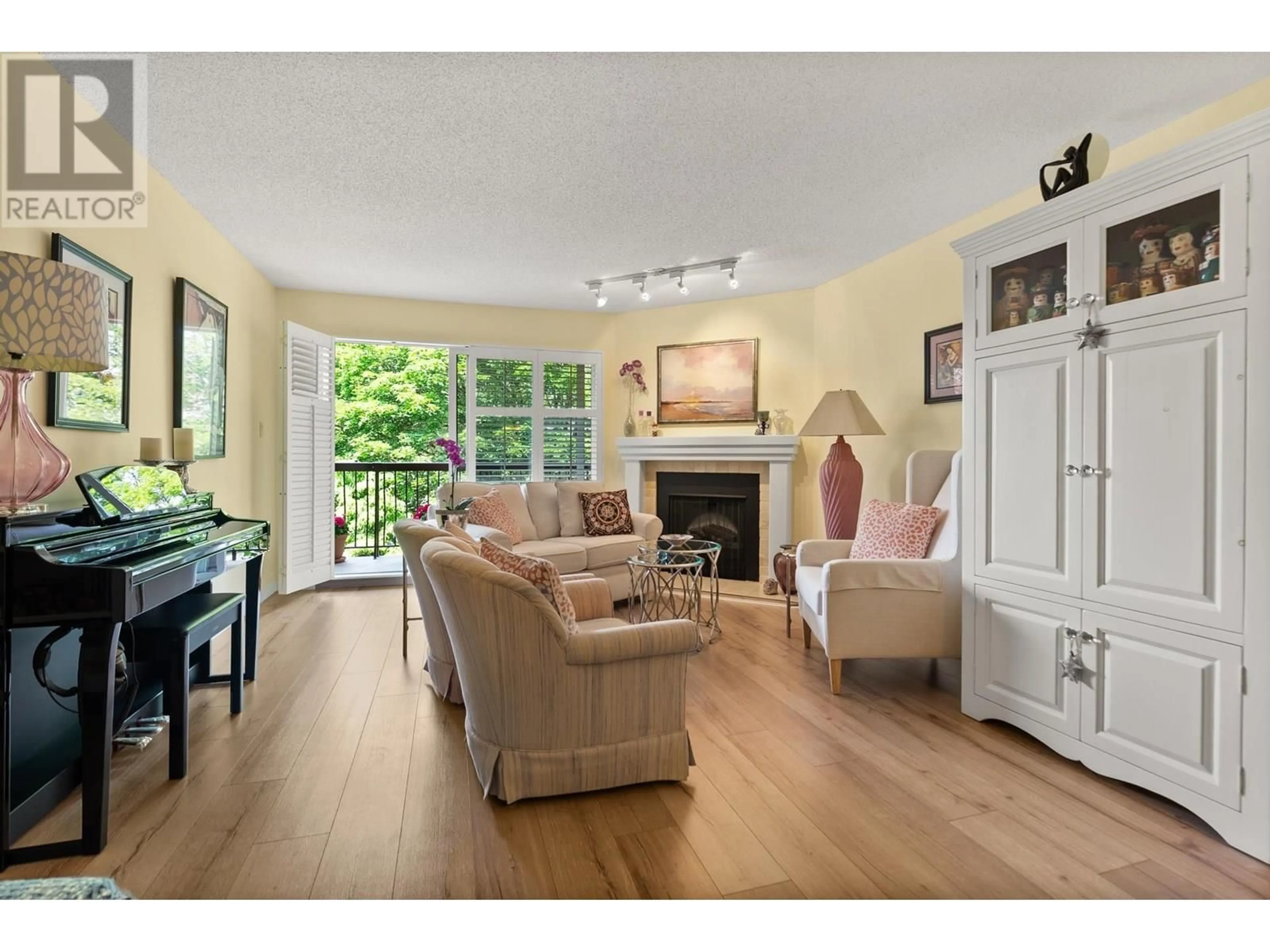 Living room with furniture, wood/laminate floor for 203 - 10180 RYAN ROAD, Richmond British Columbia V7A4P9