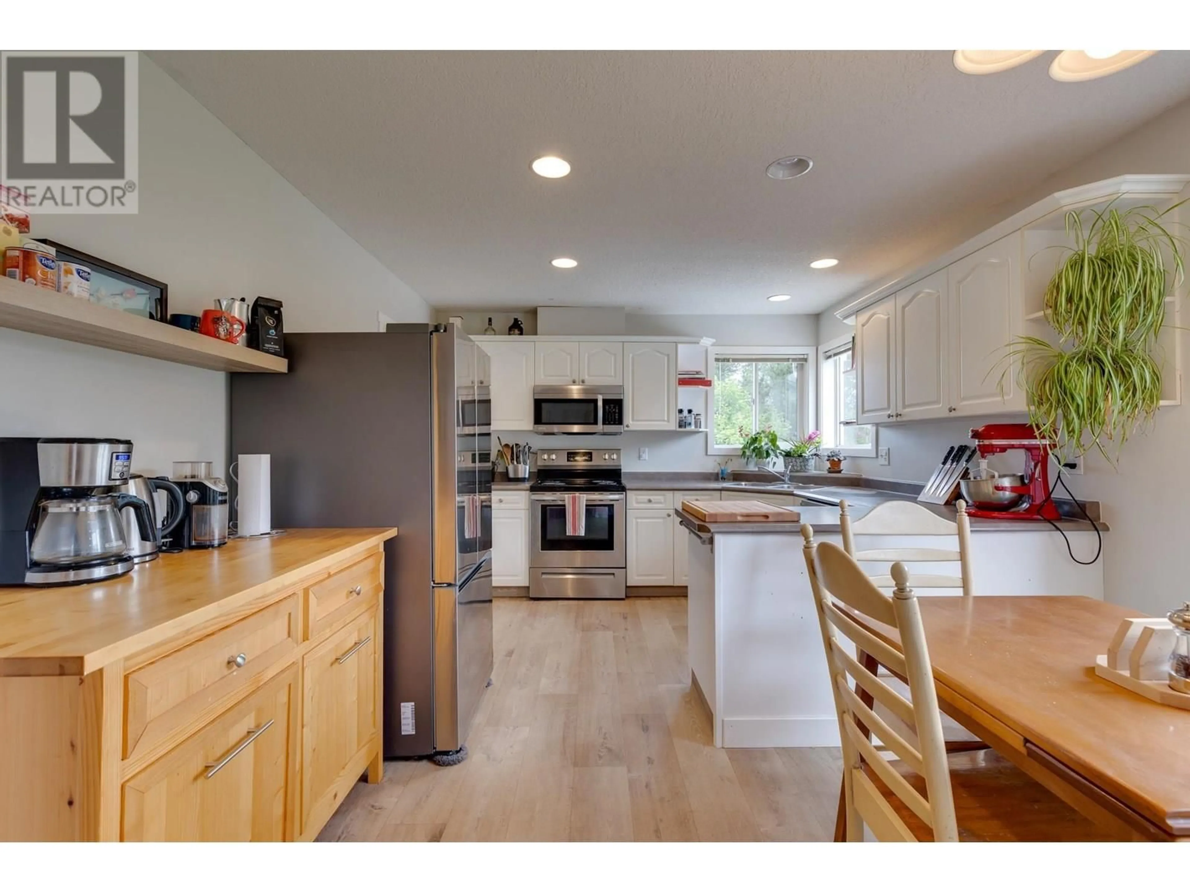Open concept kitchen, wood/laminate floor for 5581 HEYER ROAD, Prince George British Columbia V2N6P7