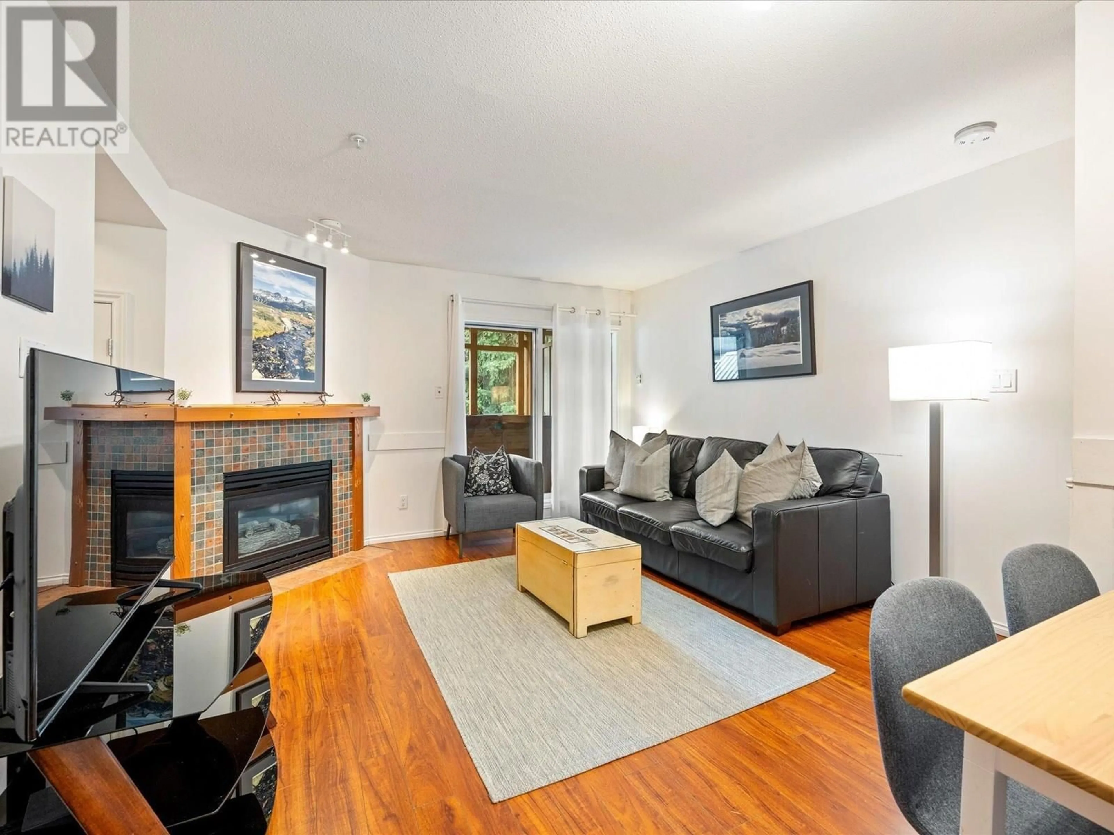 Living room with furniture, wood/laminate floor for 103 - 4388 NORTHLANDS BOULEVARD, Whistler British Columbia V8E1C6