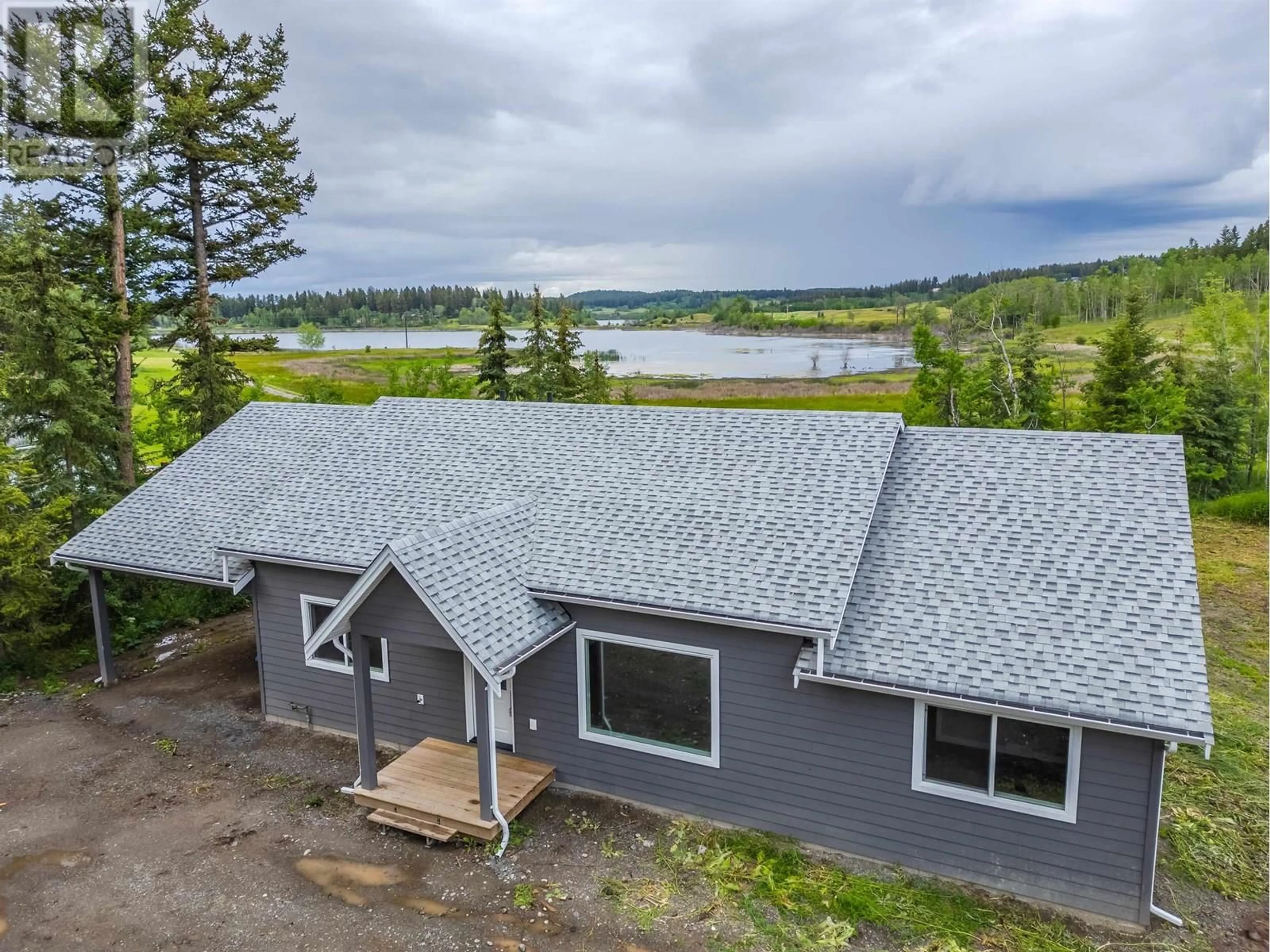 A pic from outside/outdoor area/front of a property/back of a property/a pic from drone, water/lake/river/ocean view for 5365 KALLUM DRIVE, 108 Mile Ranch British Columbia V0K2Z0