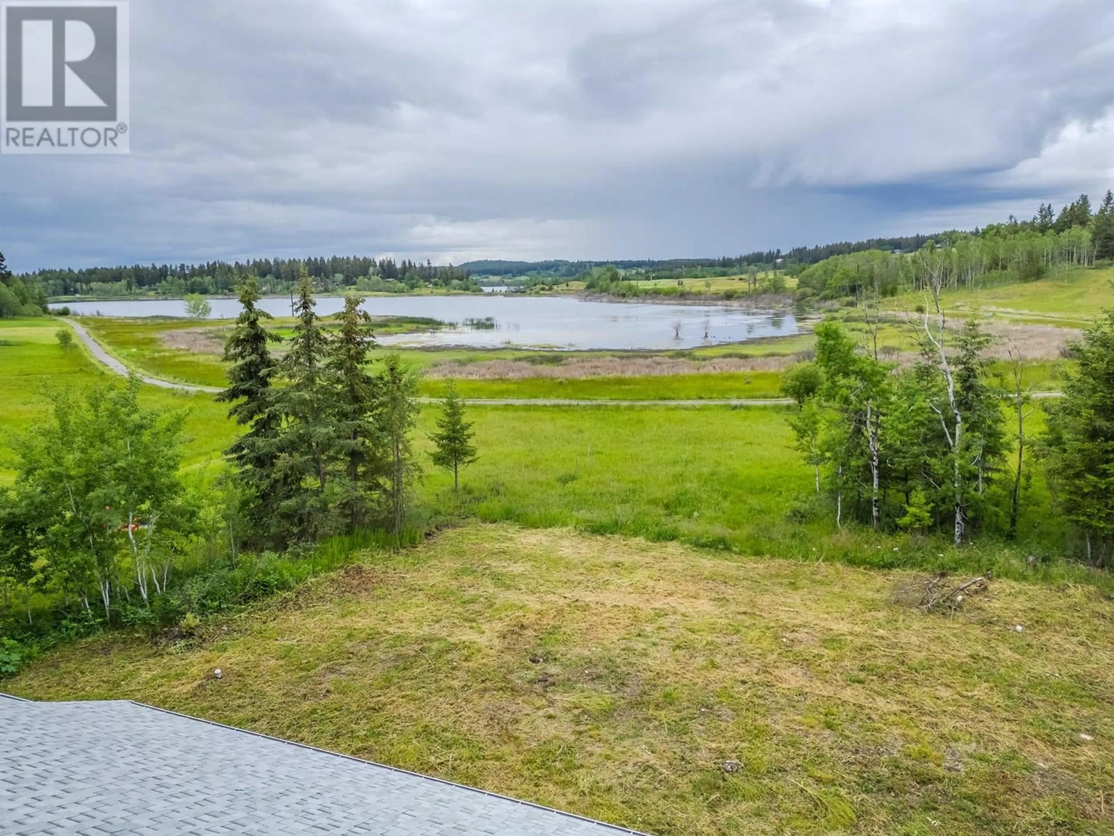 A pic from outside/outdoor area/front of a property/back of a property/a pic from drone, water/lake/river/ocean view for 5365 KALLUM DRIVE, 108 Mile Ranch British Columbia V0K2Z0