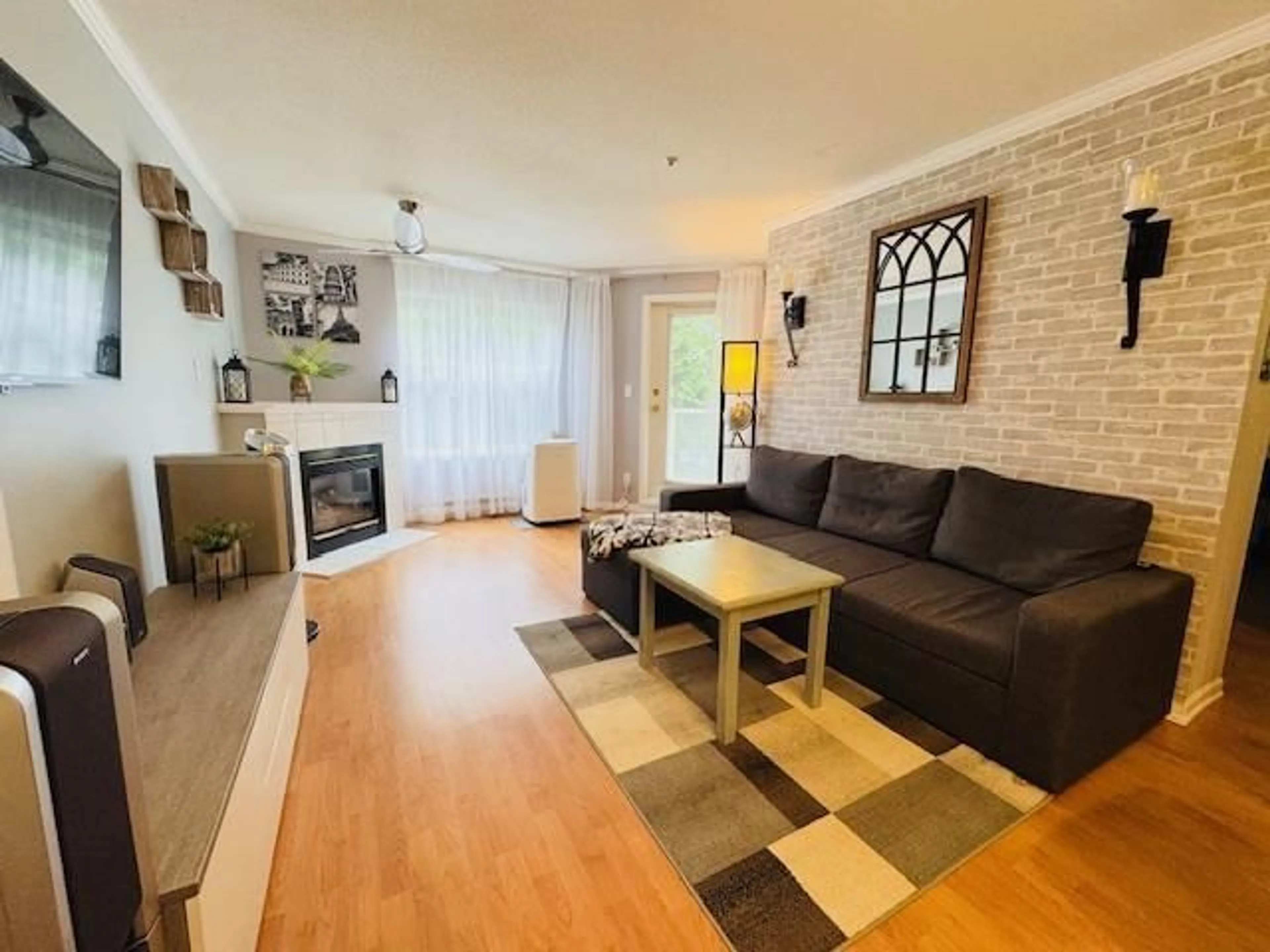 Living room with furniture, wood/laminate floor for 208 - 12739 72, Surrey British Columbia V3W2M7