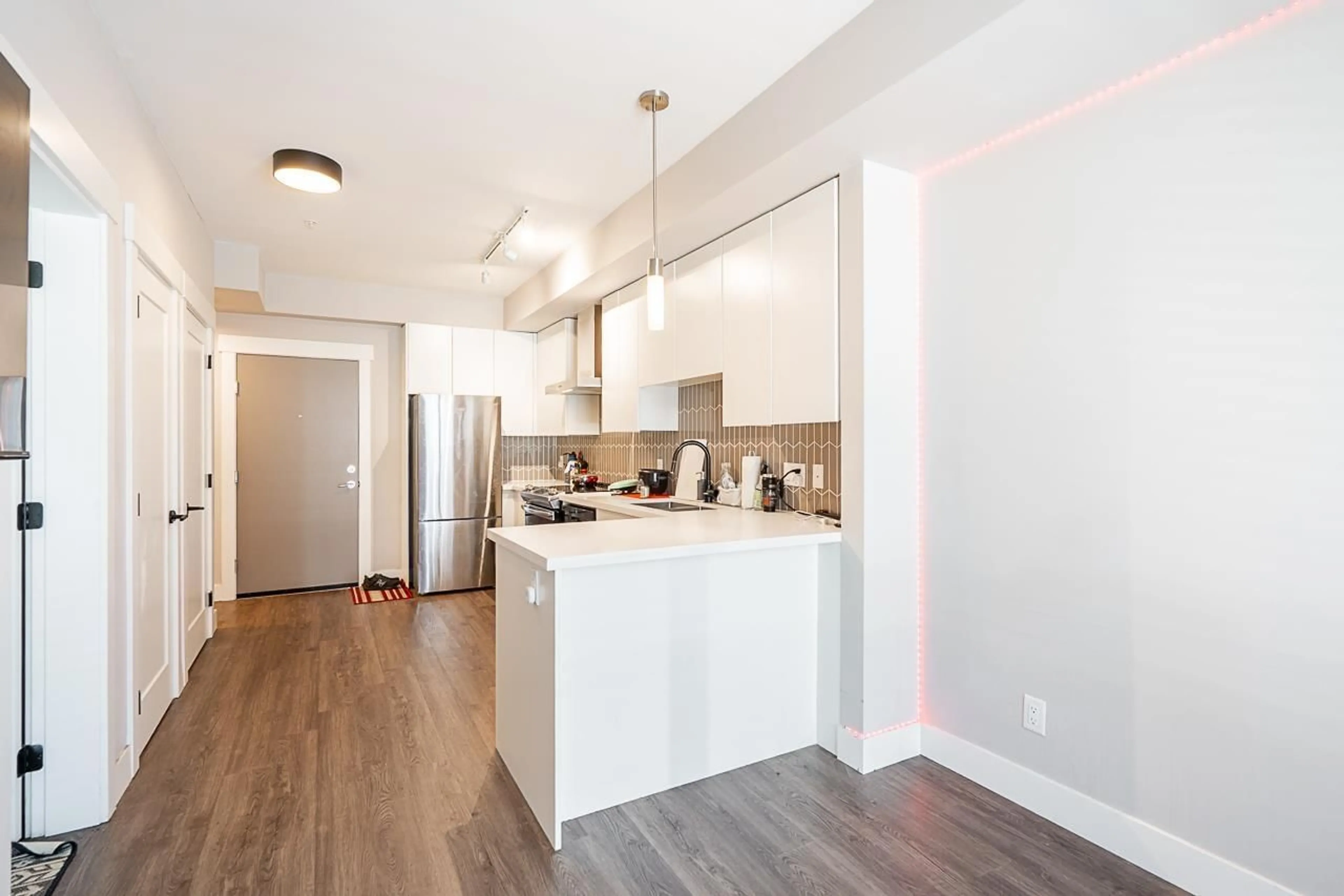 Open concept kitchen, wood/laminate floor for A114 - 20838 78B, Langley British Columbia V2Y3M1