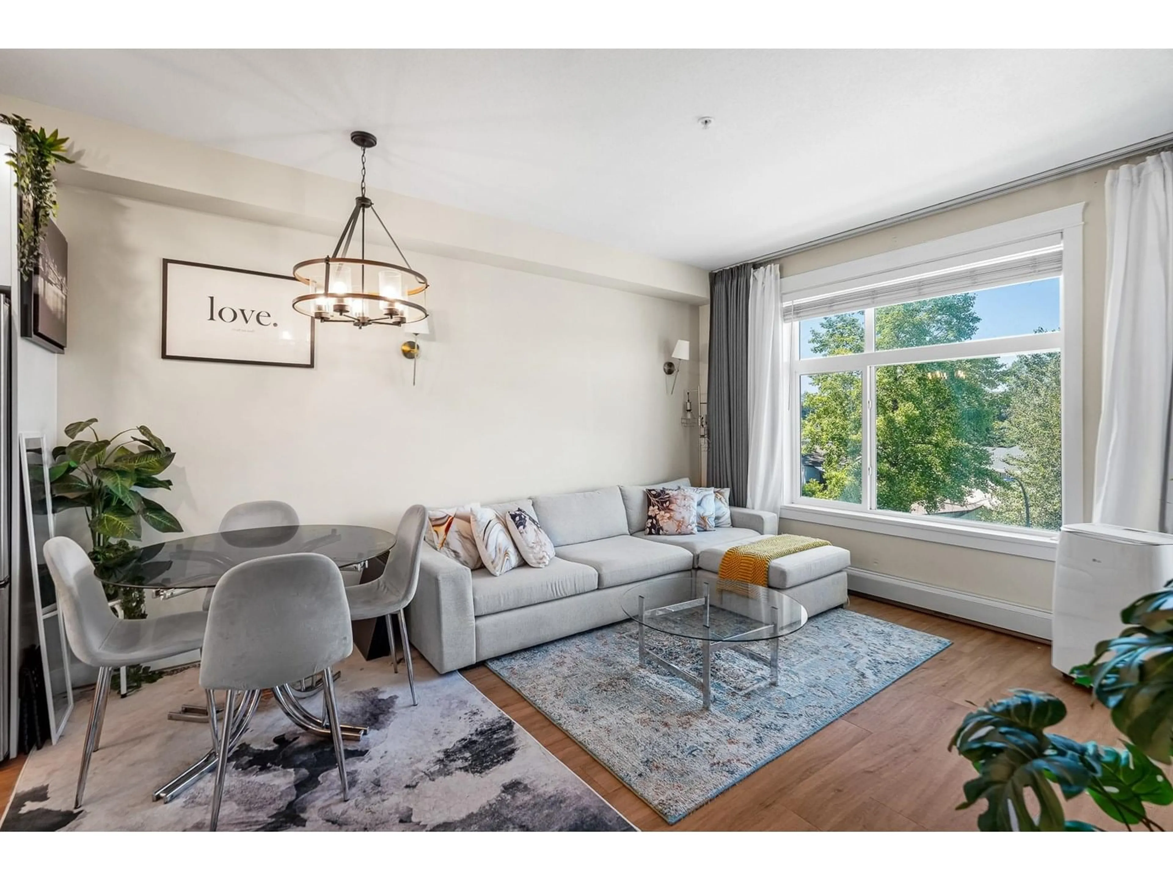 Living room with furniture, wood/laminate floor for 415 - 11077 RAVINE, Surrey British Columbia V3T0R7