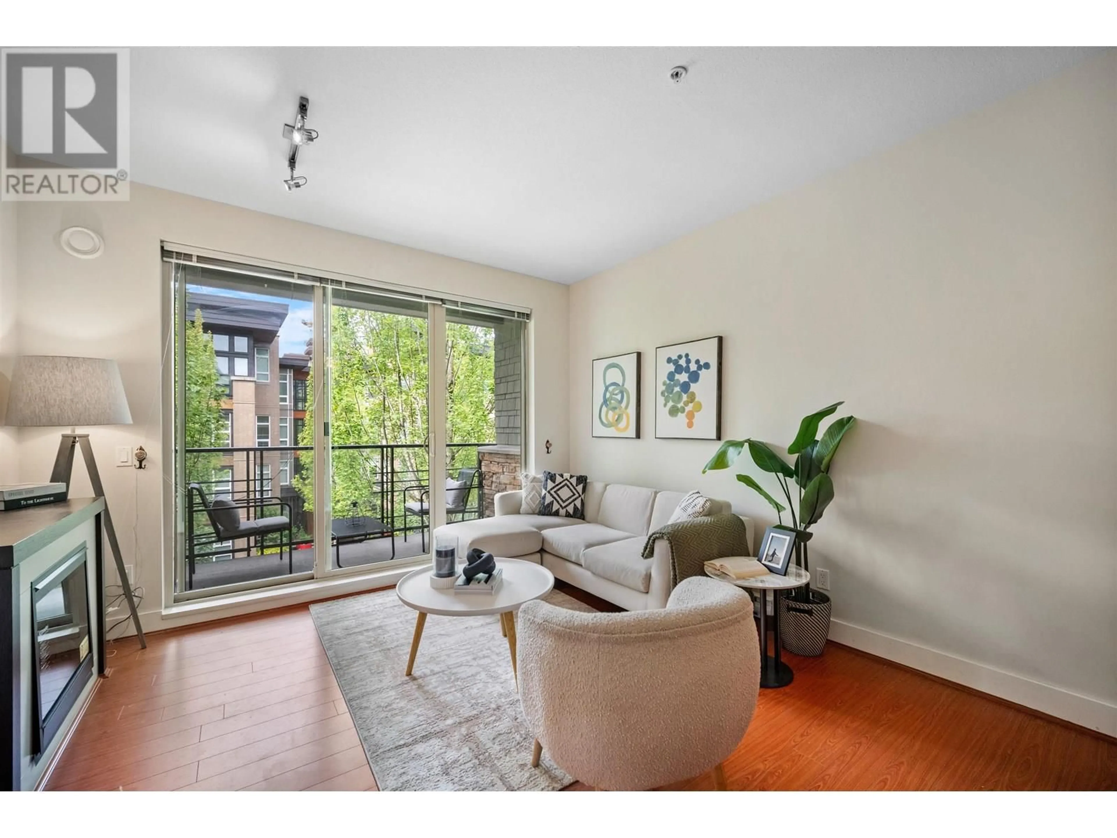 Living room with furniture, wood/laminate floor for 308 - 3478 WESBROOK MALL, Vancouver British Columbia V6S0B6