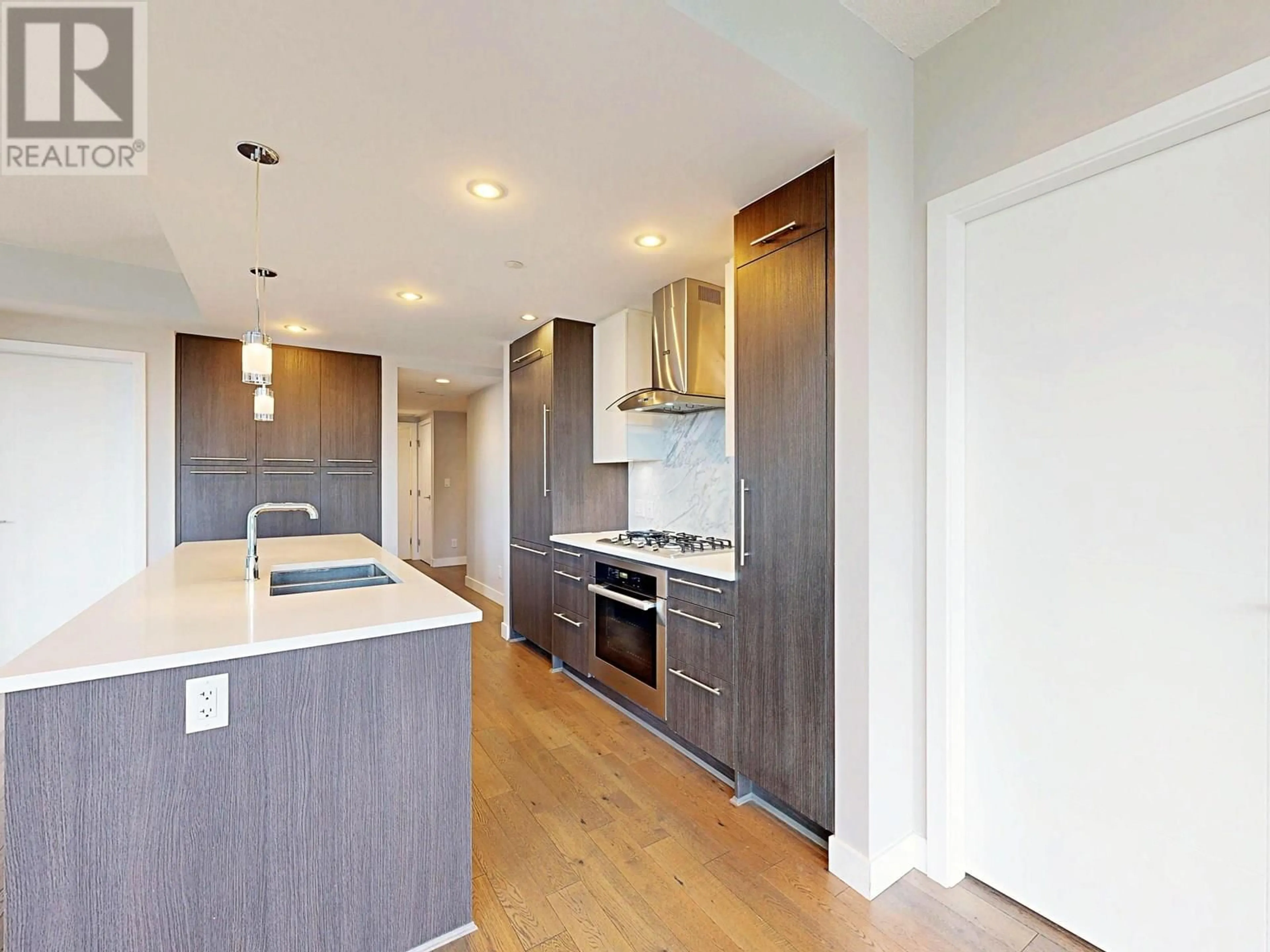 Open concept kitchen, wood/laminate floor for 408 - 677 41ST AVENUE, Vancouver British Columbia V5Z2N1