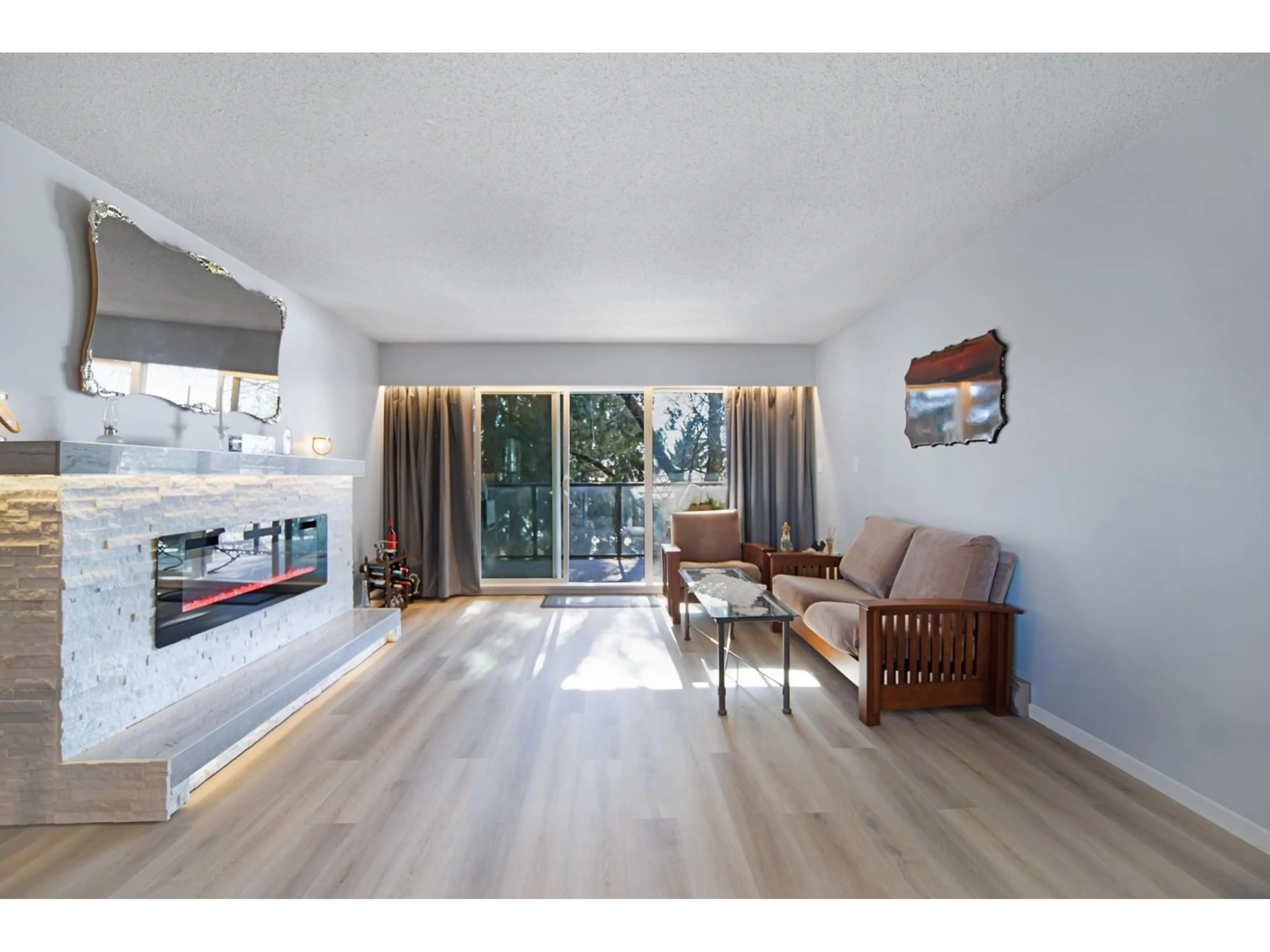 Living room with furniture, wood/laminate floor for 203 - 32040 PEARDONVILLE, Abbotsford British Columbia V2T6N8