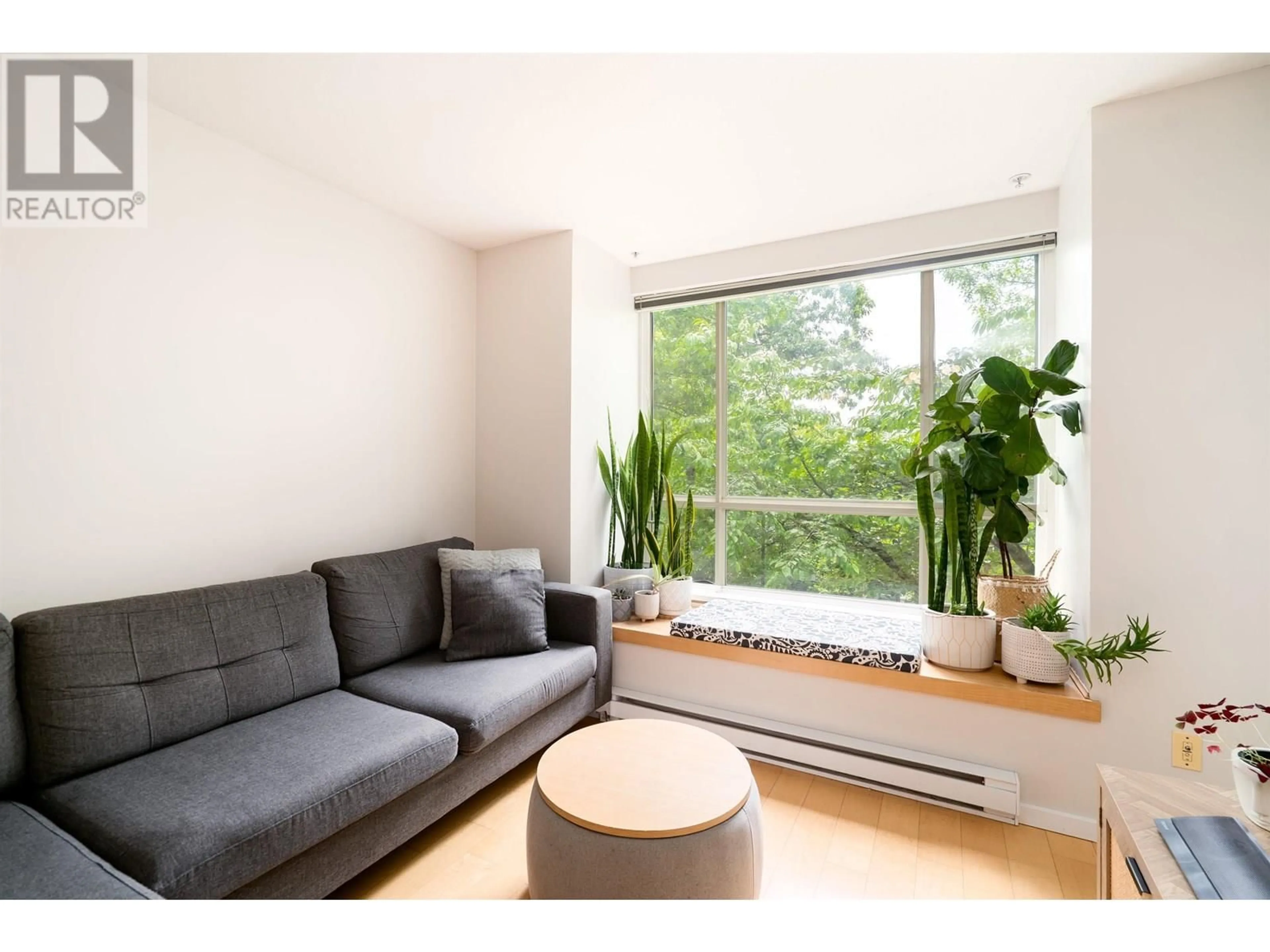 Living room with furniture, wood/laminate floor for 202 - 6833 VILLAGE, Burnaby British Columbia V5E4M1