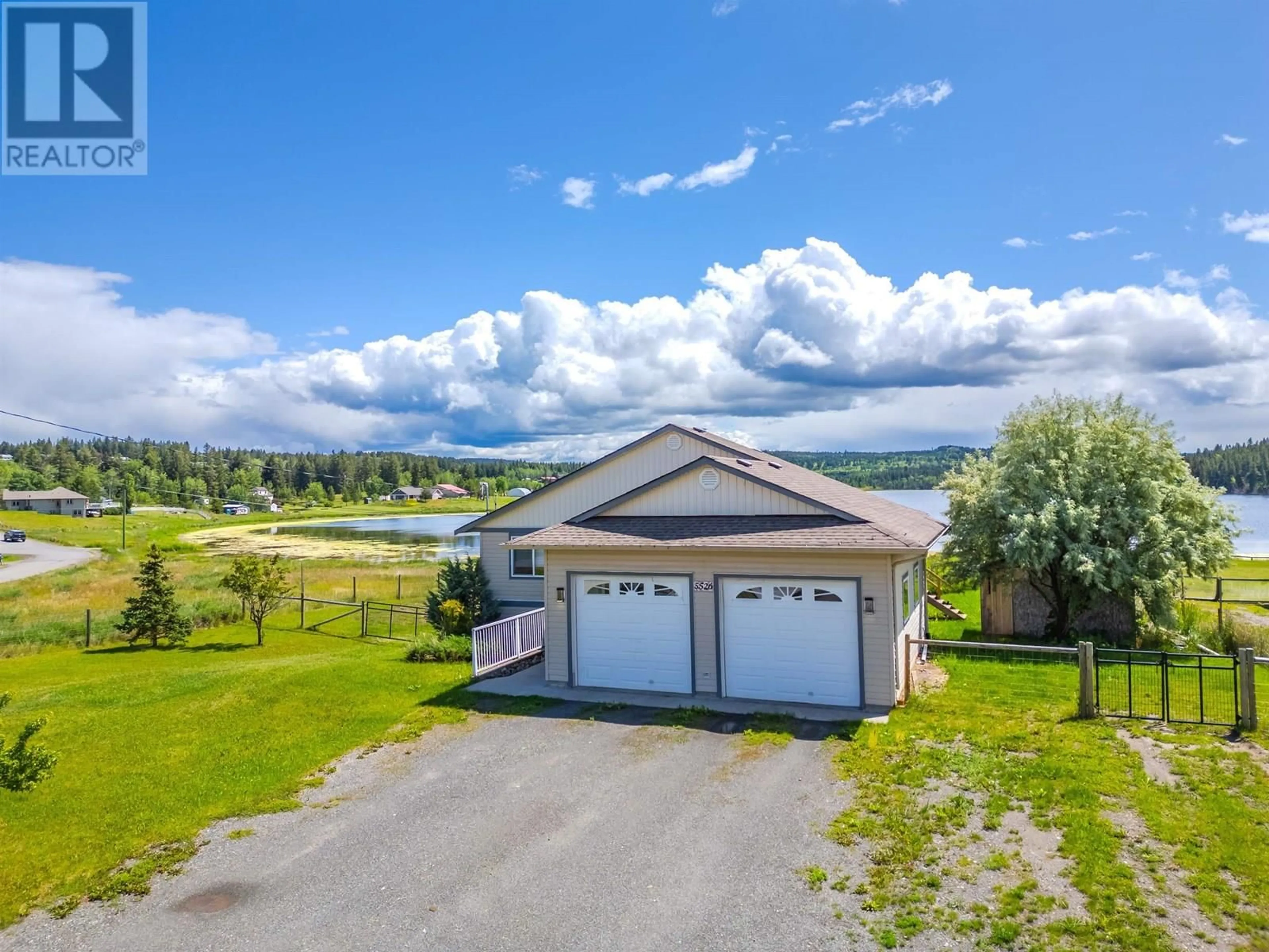 A pic from outside/outdoor area/front of a property/back of a property/a pic from drone, water/lake/river/ocean view for 5526 LAKESIDE COURT, 103 Mile House British Columbia V0K2E1