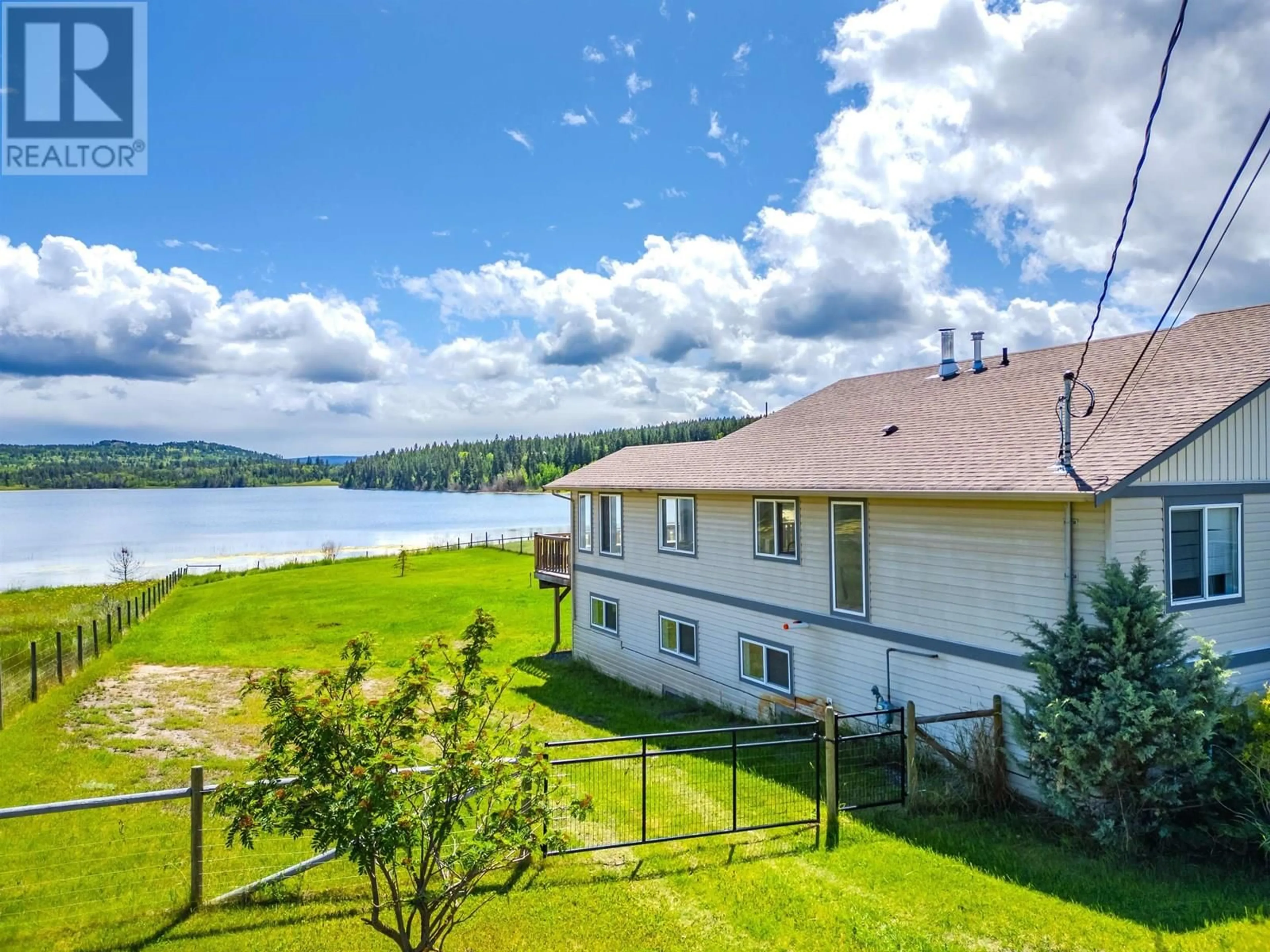 A pic from outside/outdoor area/front of a property/back of a property/a pic from drone, water/lake/river/ocean view for 5526 LAKESIDE COURT, 103 Mile House British Columbia V0K2E1