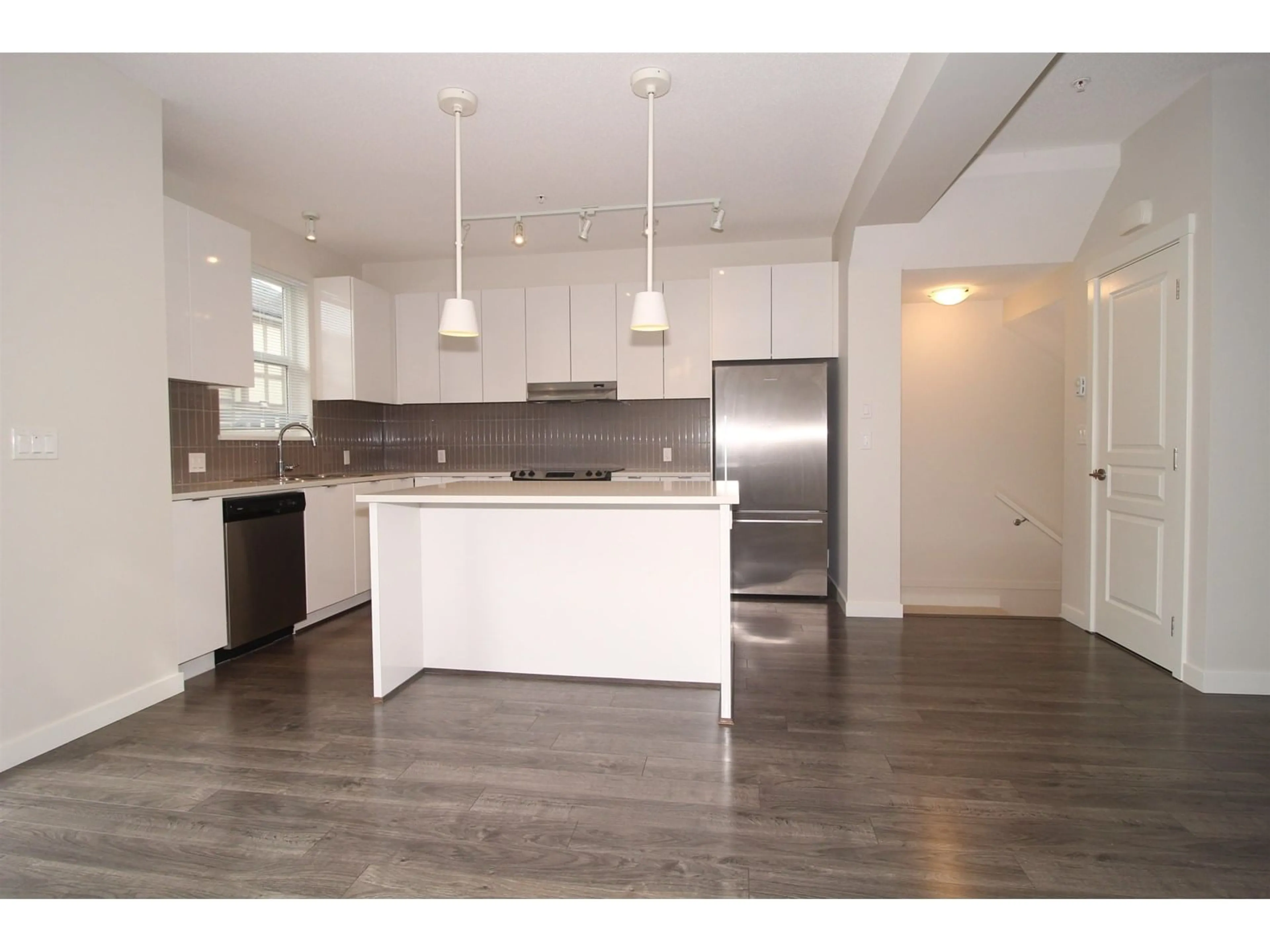 Open concept kitchen, wood/laminate floor for 108 - 7848 209, Langley British Columbia V2Y0M4