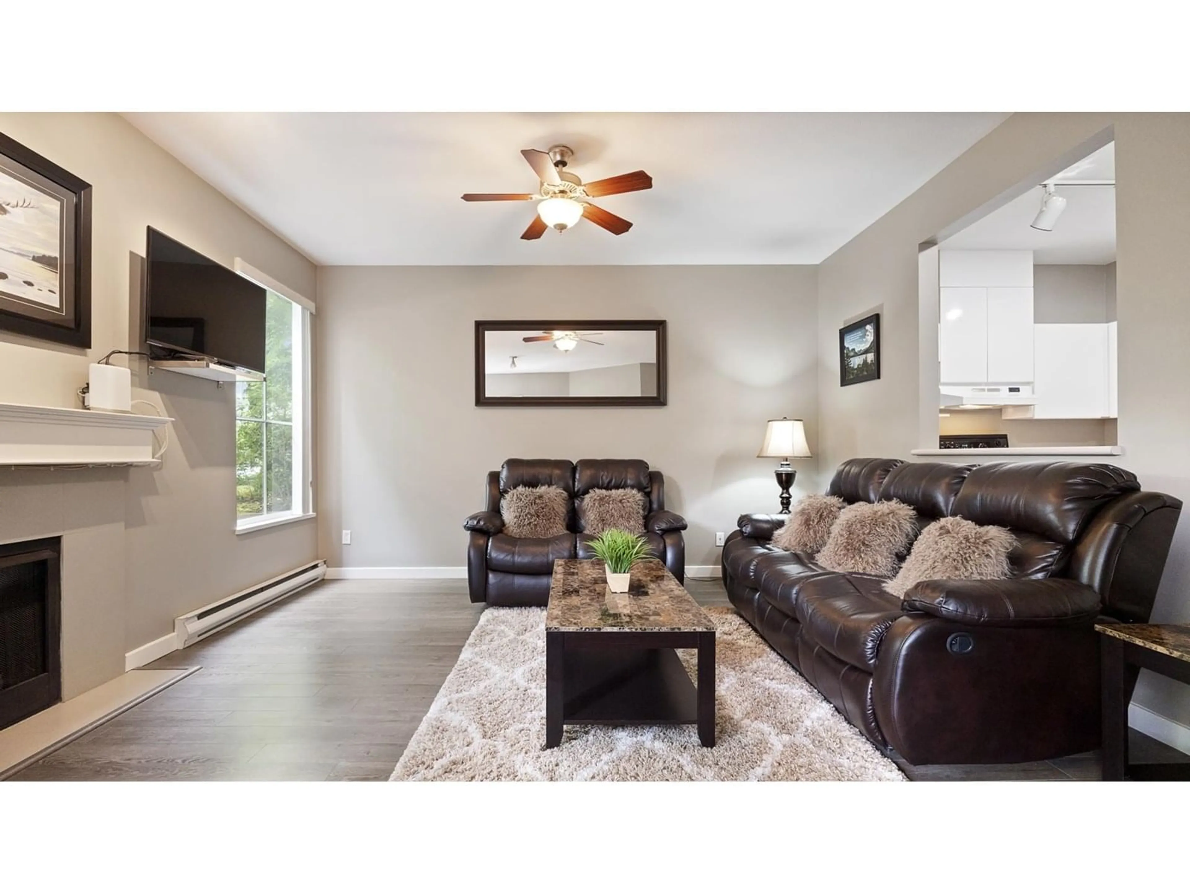 Living room with furniture, wood/laminate floor for 105 - 14998 101A, Surrey British Columbia V3R0T1