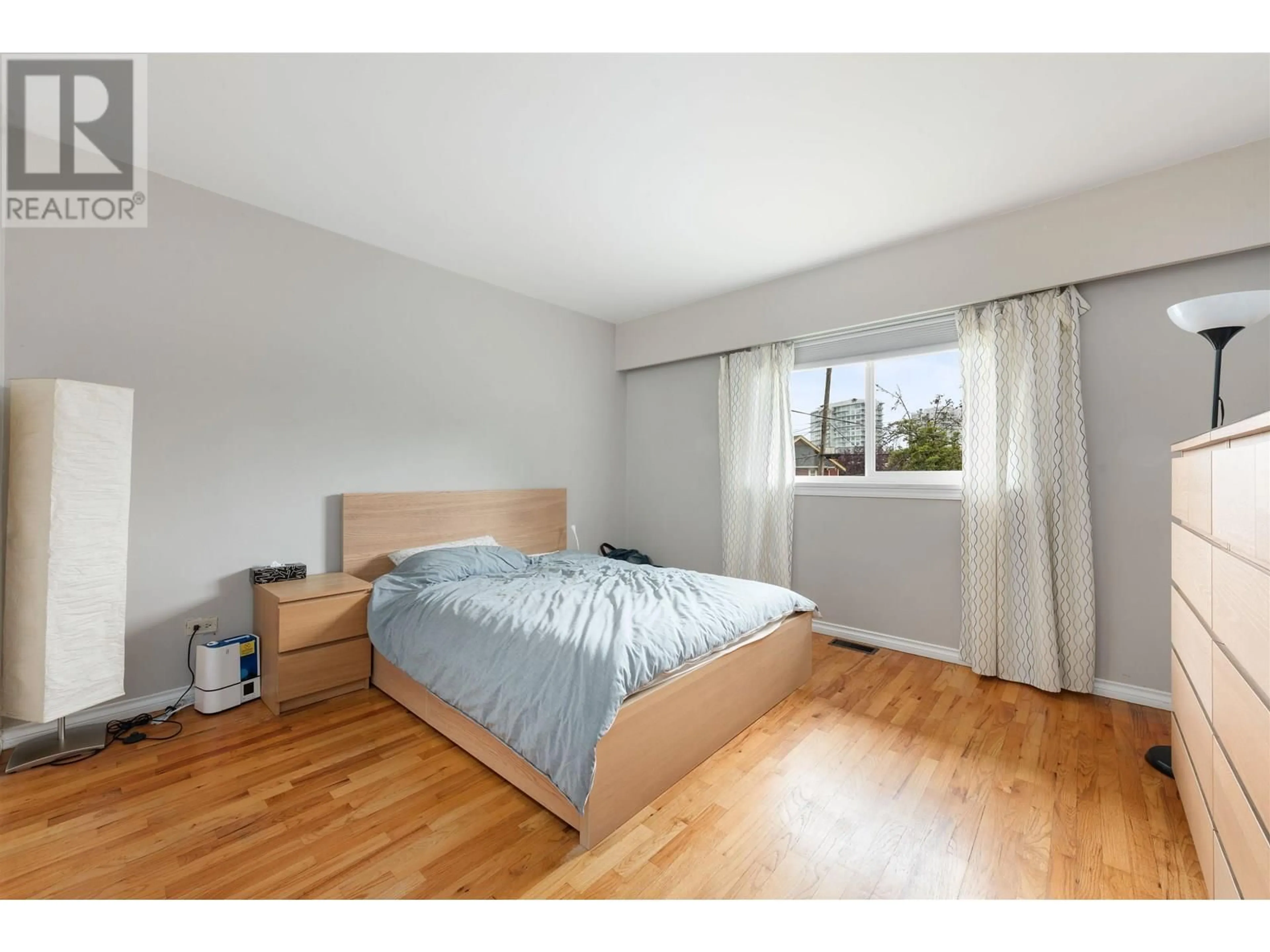 Bedroom with bed, wood/laminate floor for 4561 NANAIMO STREET, Vancouver British Columbia V5N5J5