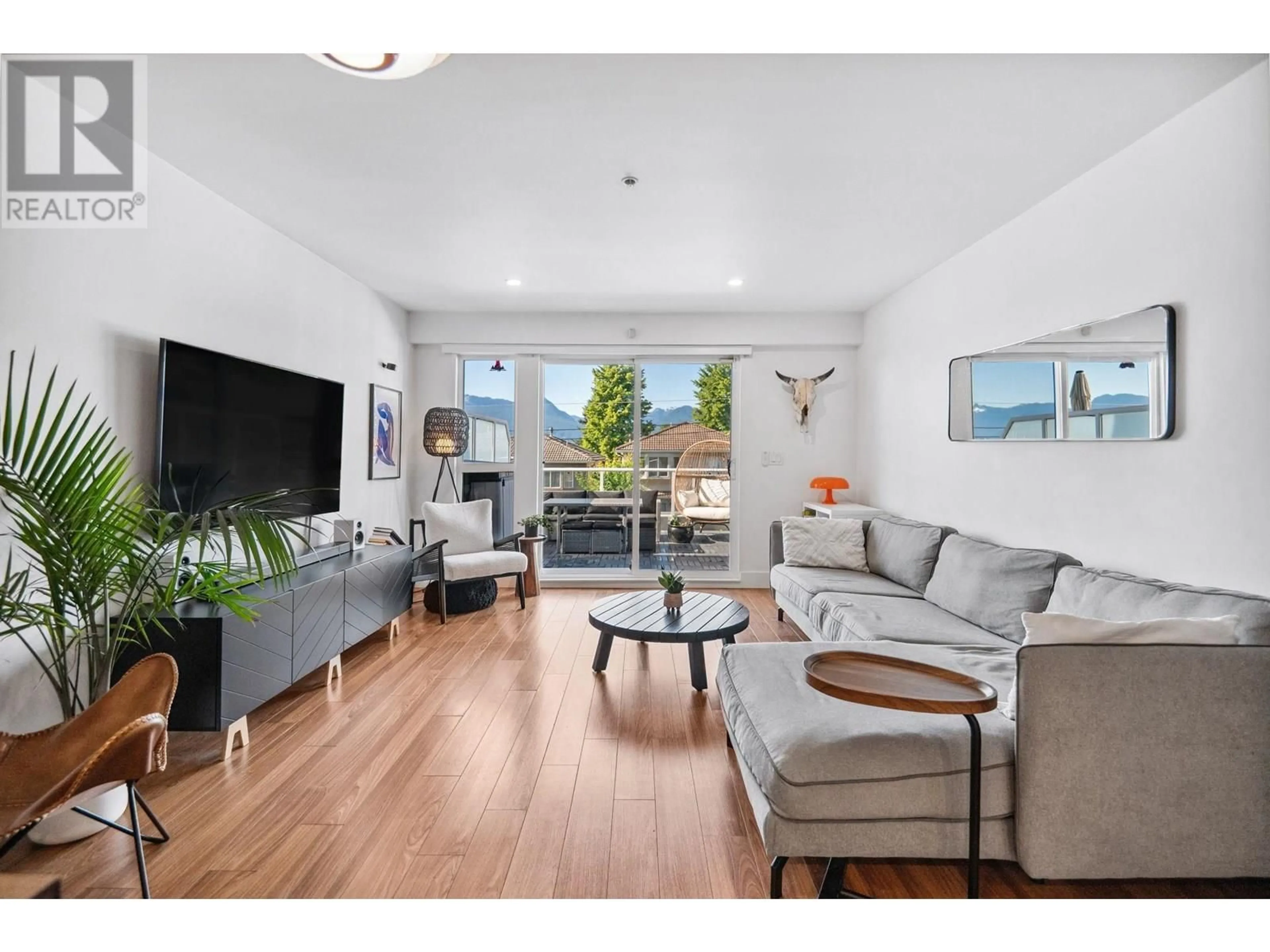Living room with furniture, wood/laminate floor for 312 - 3423 HASTINGS STREET, Vancouver British Columbia V5K2A5