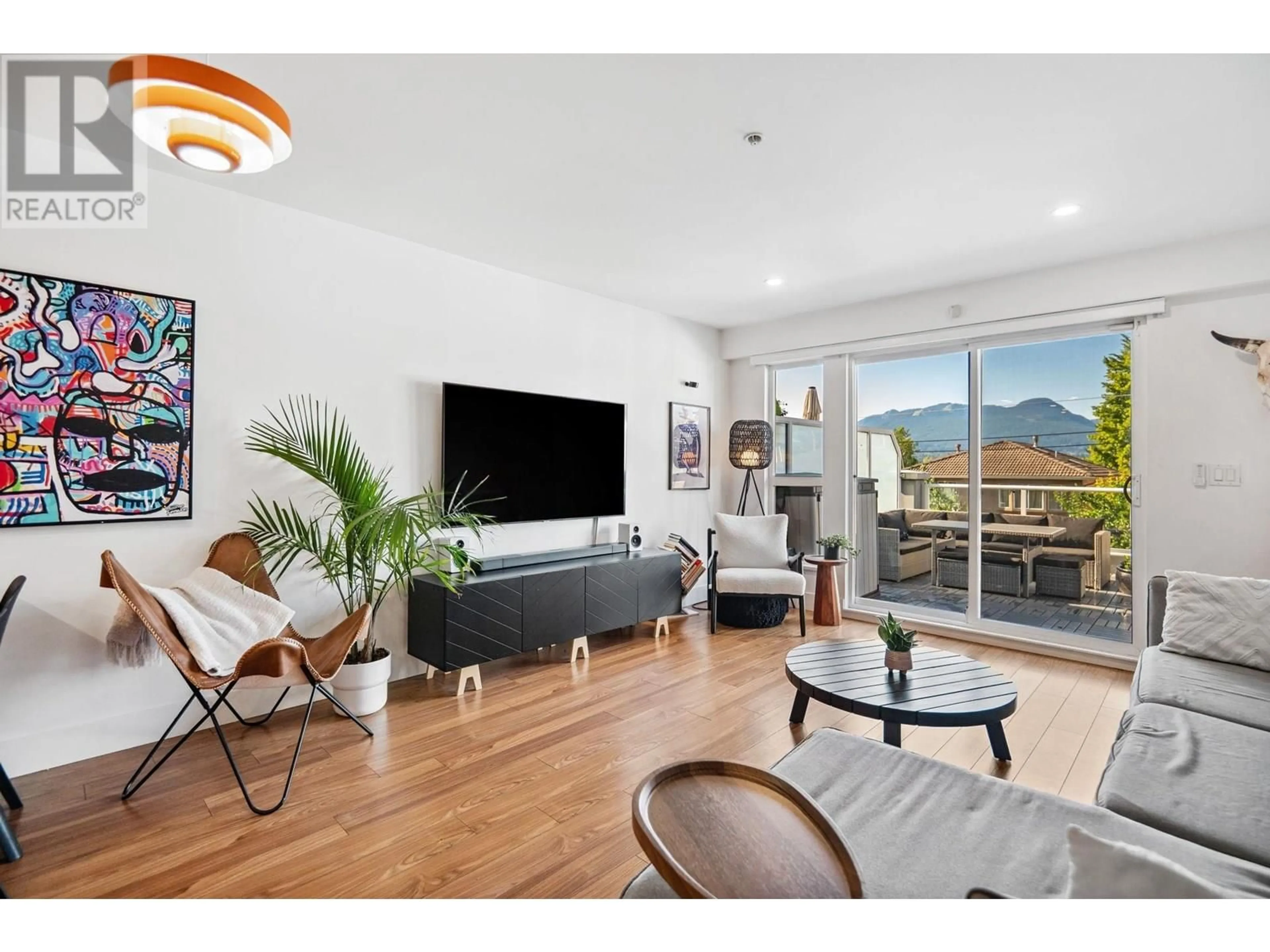 Living room with furniture, wood/laminate floor for 312 - 3423 HASTINGS STREET, Vancouver British Columbia V5K2A5