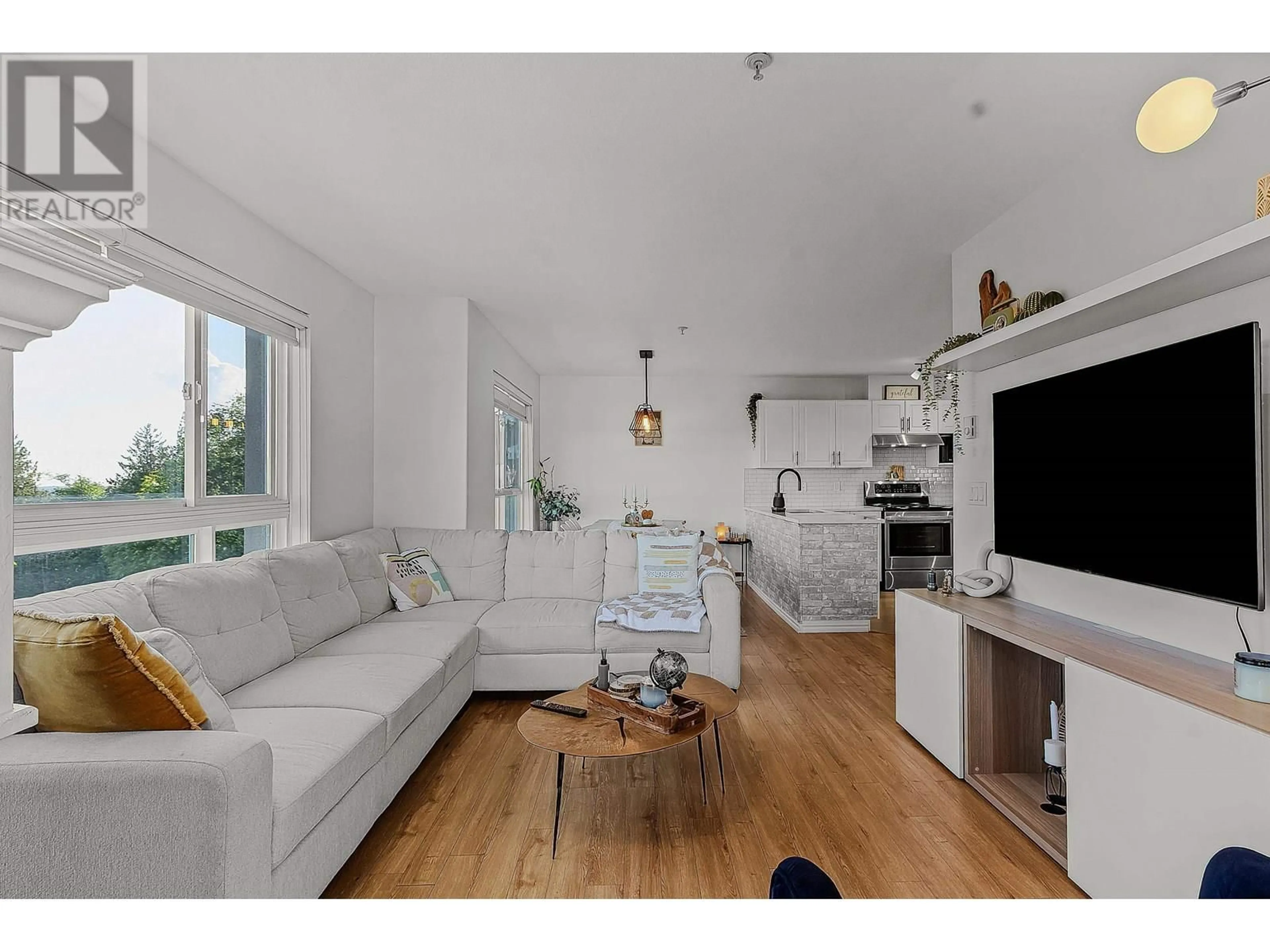 Living room with furniture, wood/laminate floor for 501 - 22230 NORTH AVENUE, Maple Ridge British Columbia V2X2L5
