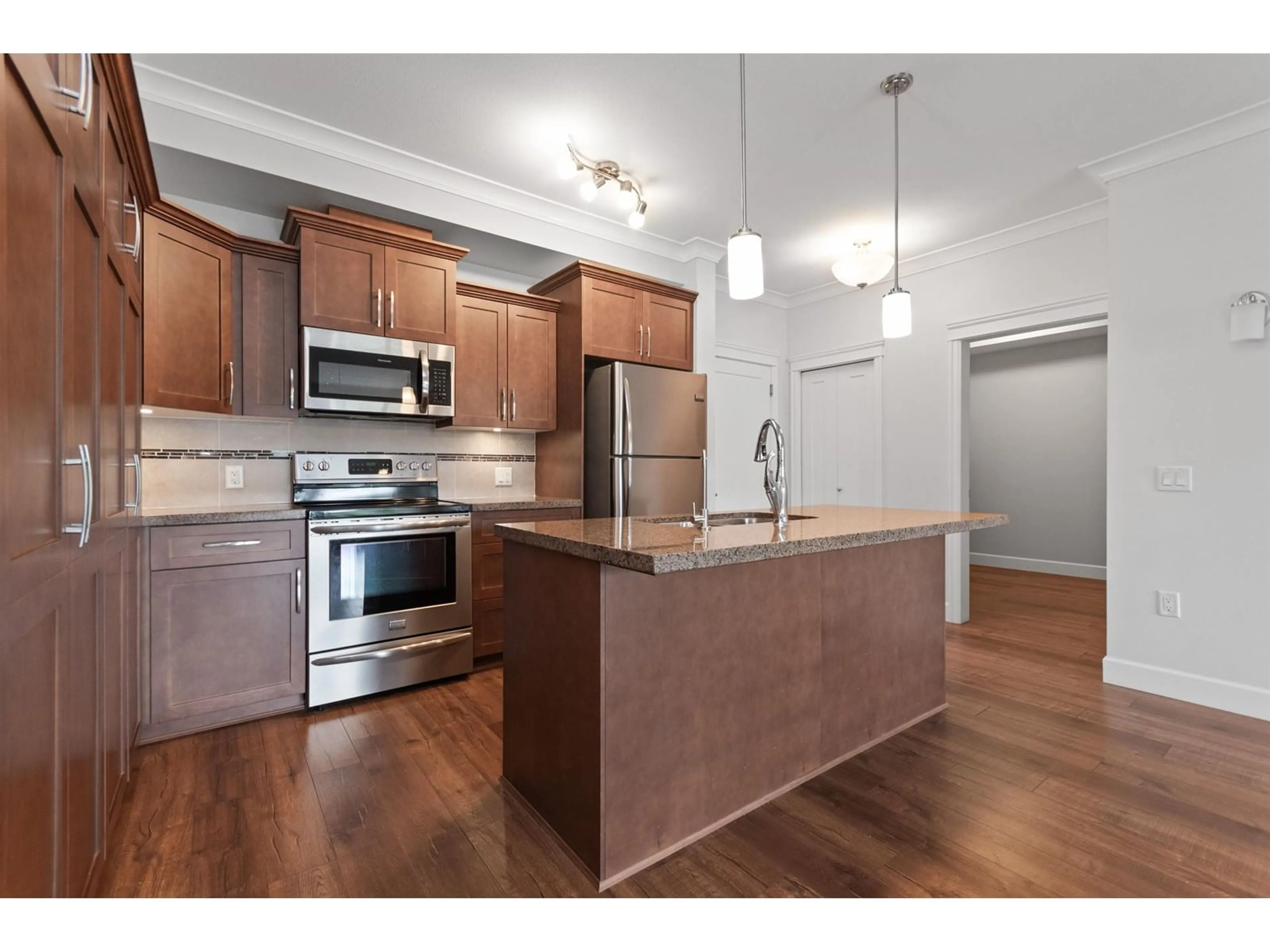 Open concept kitchen, wood/laminate floor for 301 - 45750 KEITH WILSON ROAD, Chilliwack British Columbia V2R0X3