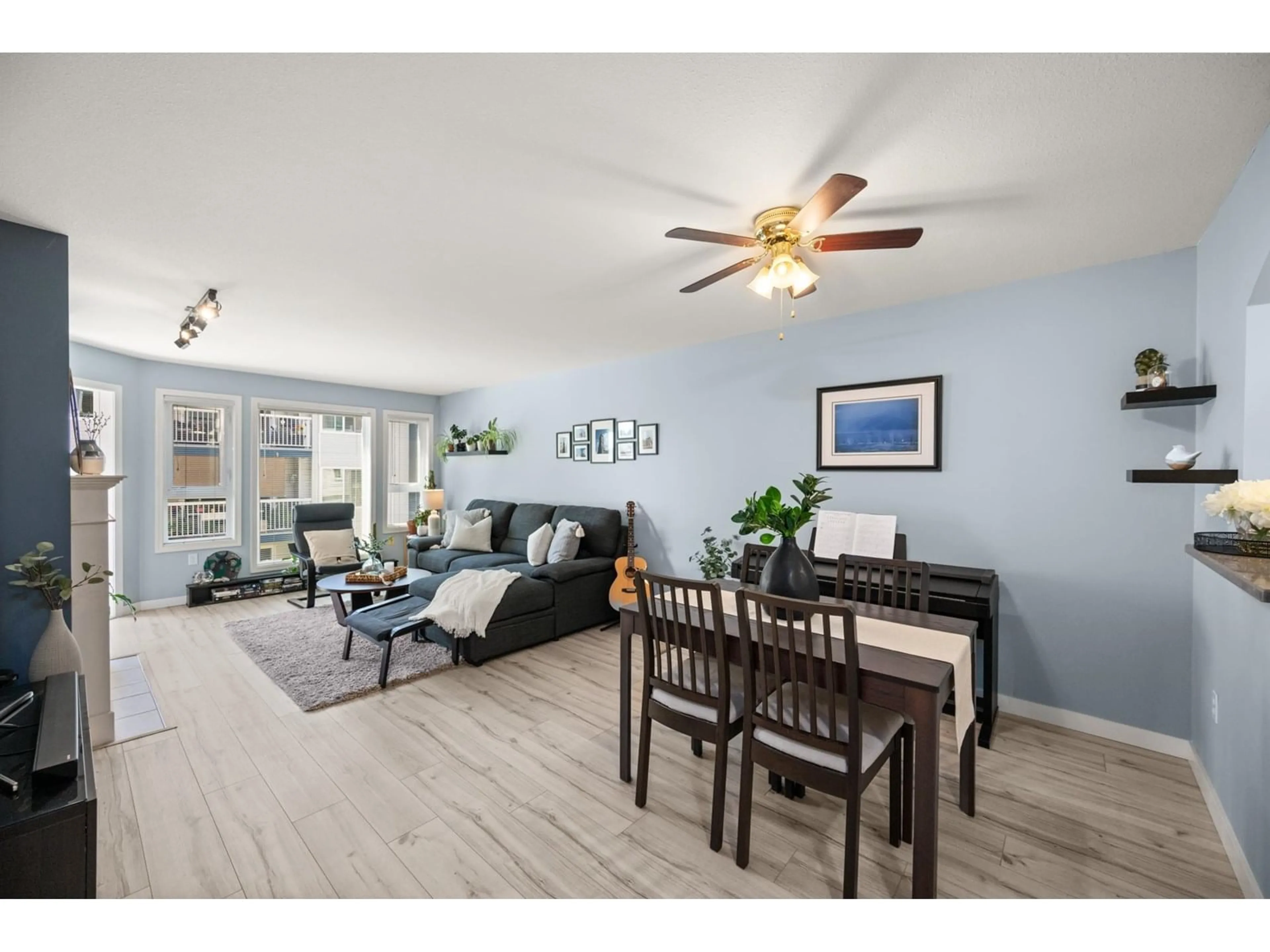 Living room with furniture, wood/laminate floor for 209 - 17727 58, Surrey British Columbia V3S1L5