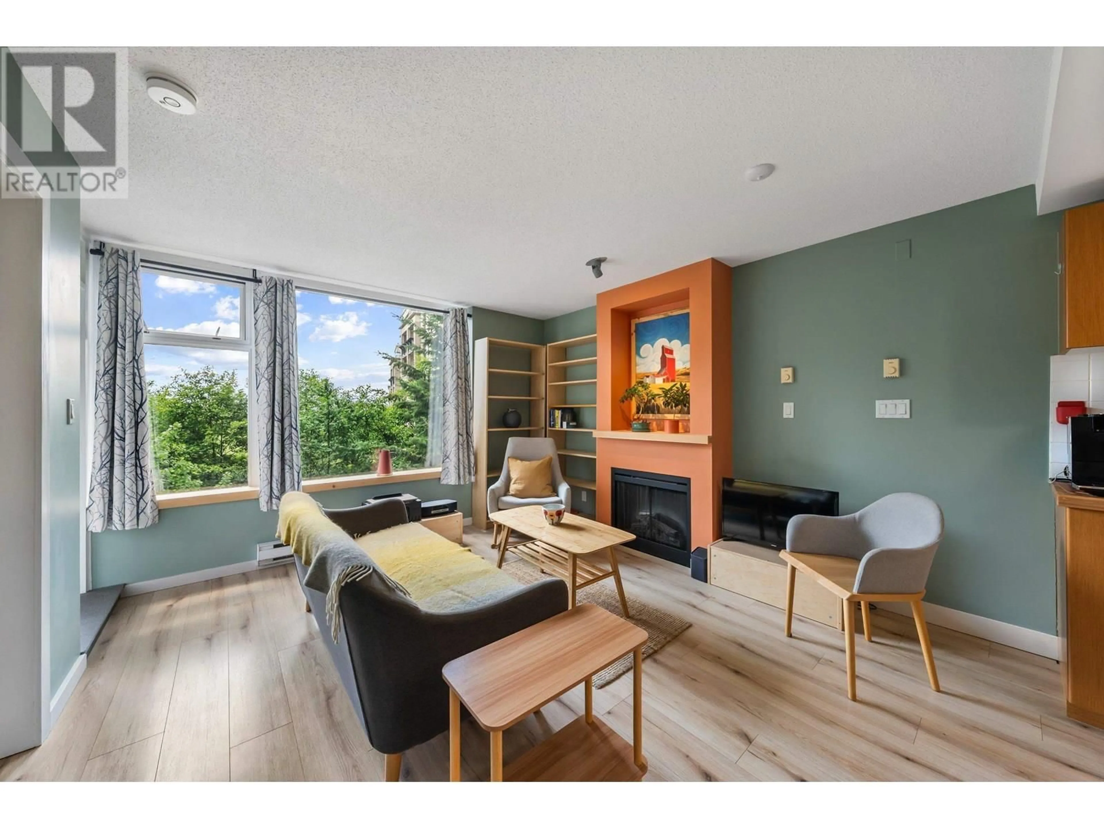 Living room with furniture, wood/laminate floor for 309 - 9298 UNIVERSITY CRESCENT, Burnaby British Columbia V5A4X8