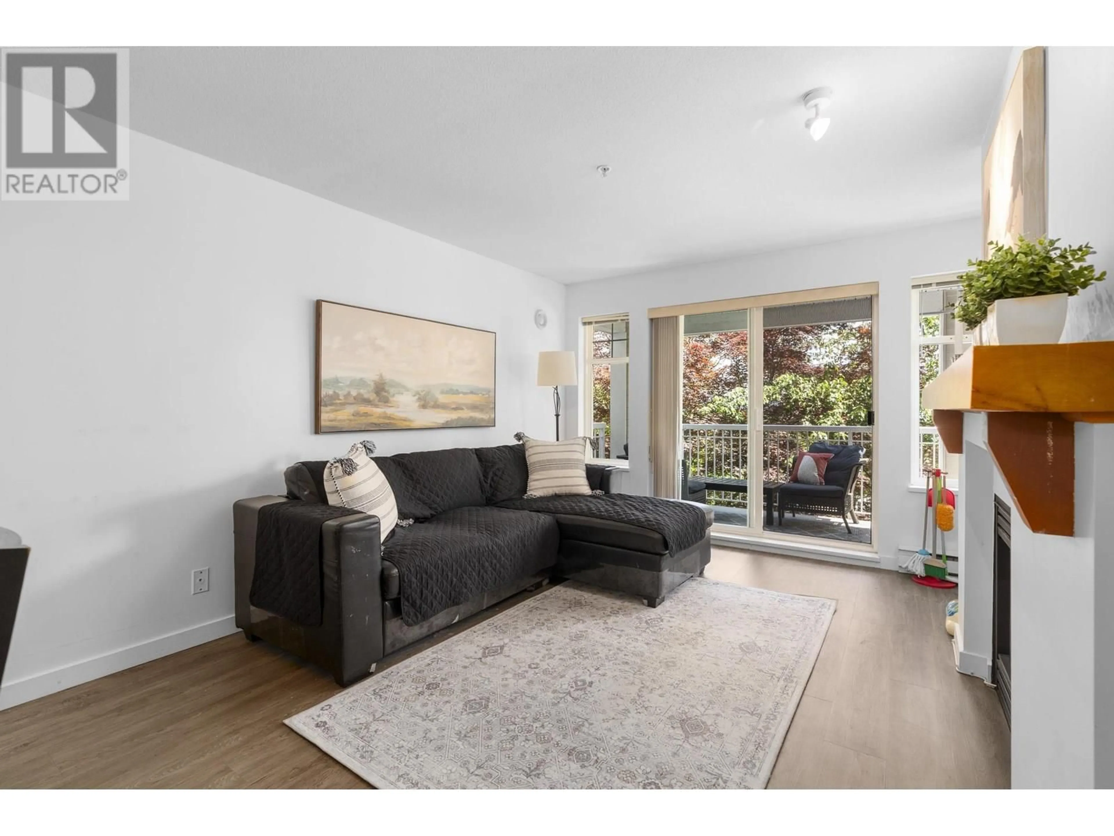 Living room with furniture, wood/laminate floor for 212 - 1432 PARKWAY BOULEVARD, Coquitlam British Columbia V3E3L9