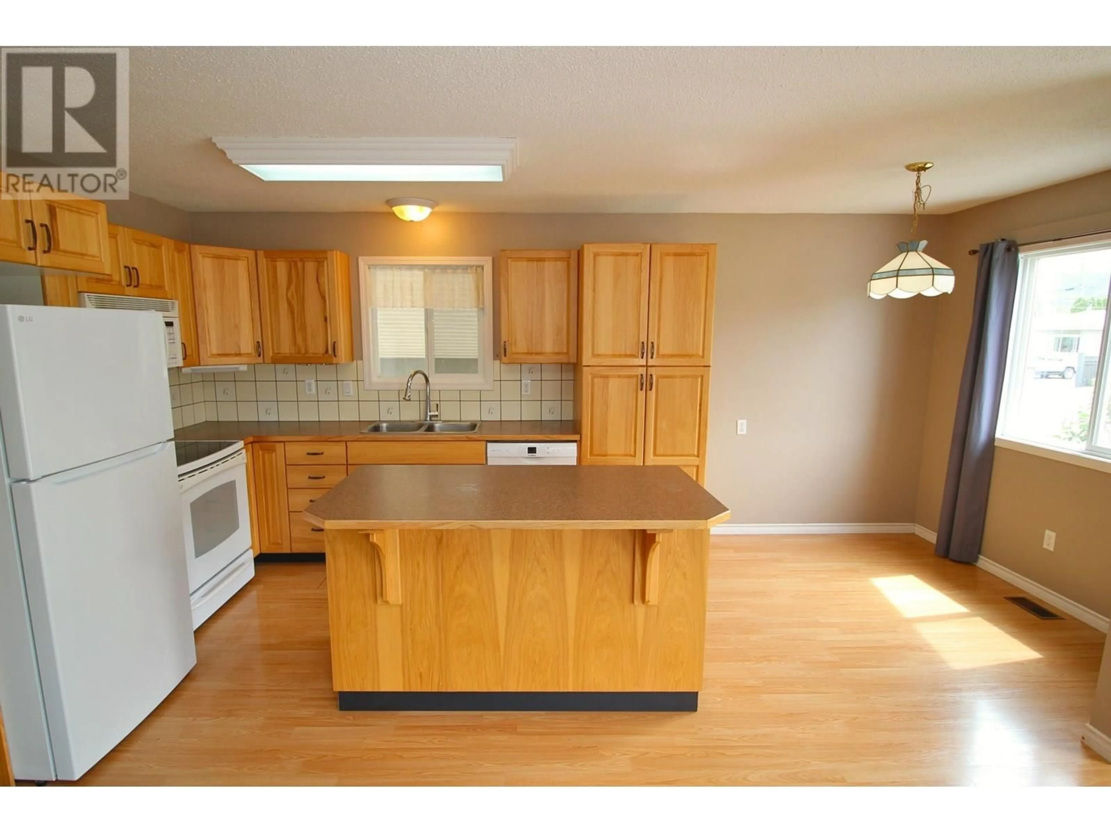 Open concept kitchen, wood/laminate floor for 3391 13TH STREET, Houston British Columbia V0J1Z0