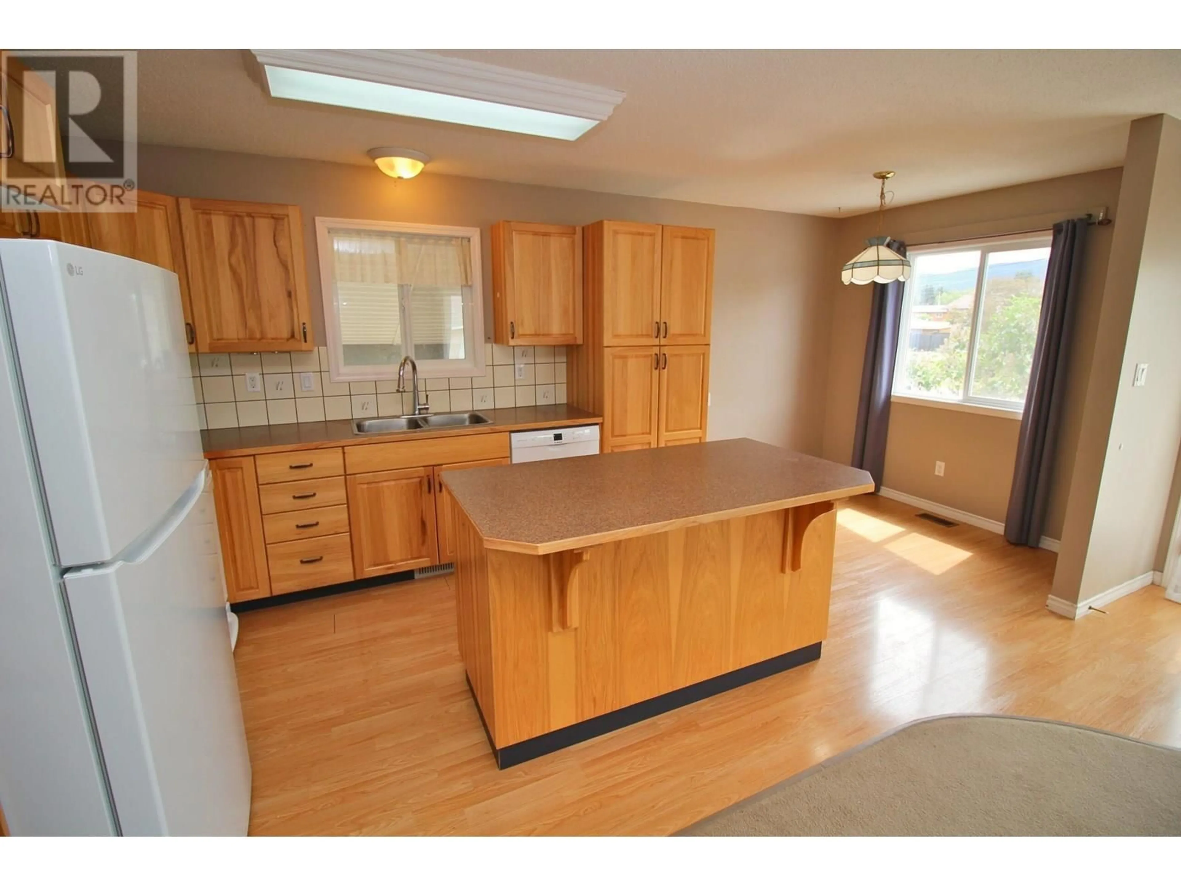 Open concept kitchen, wood/laminate floor for 3391 13TH STREET, Houston British Columbia V0J1Z0