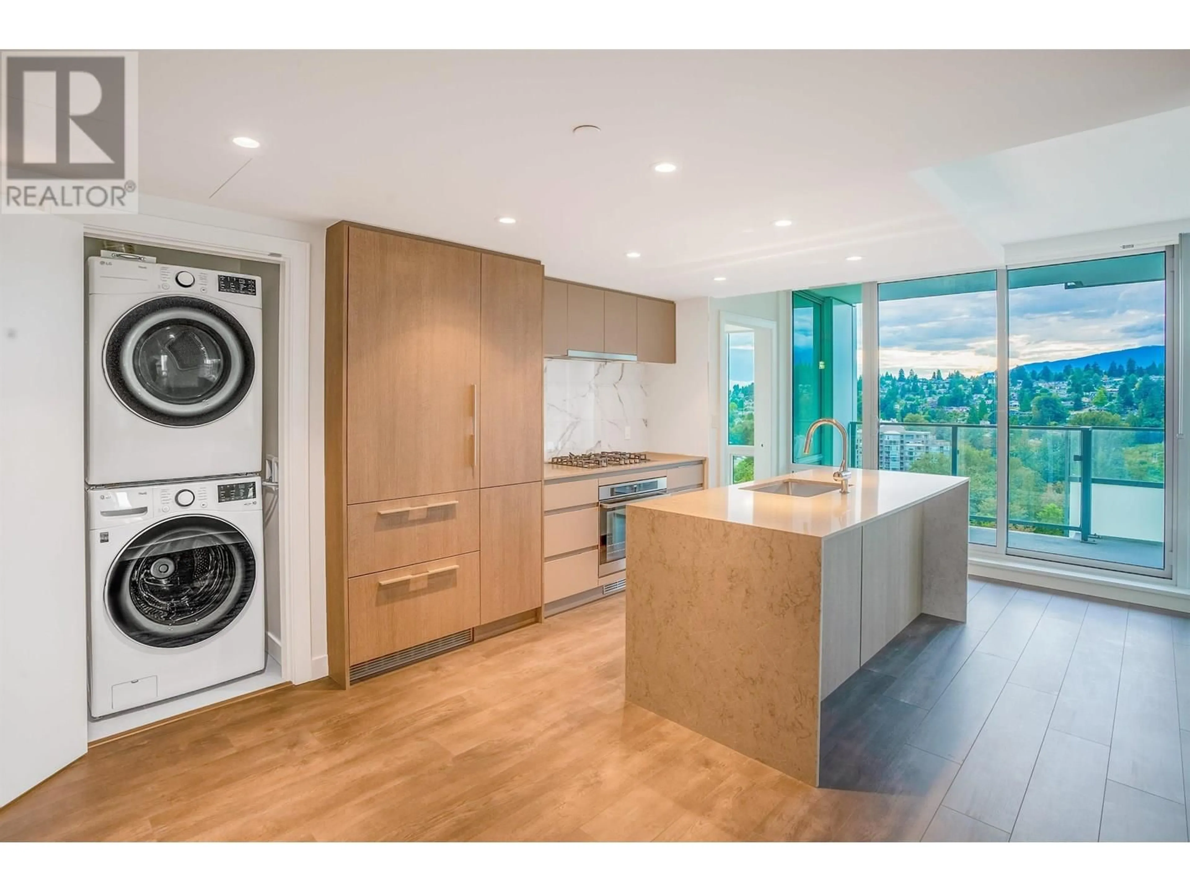 Kitchen with laundary machines, wood/laminate floor for 2201 - 1500 FERN STREET, North Vancouver British Columbia V7J0B6