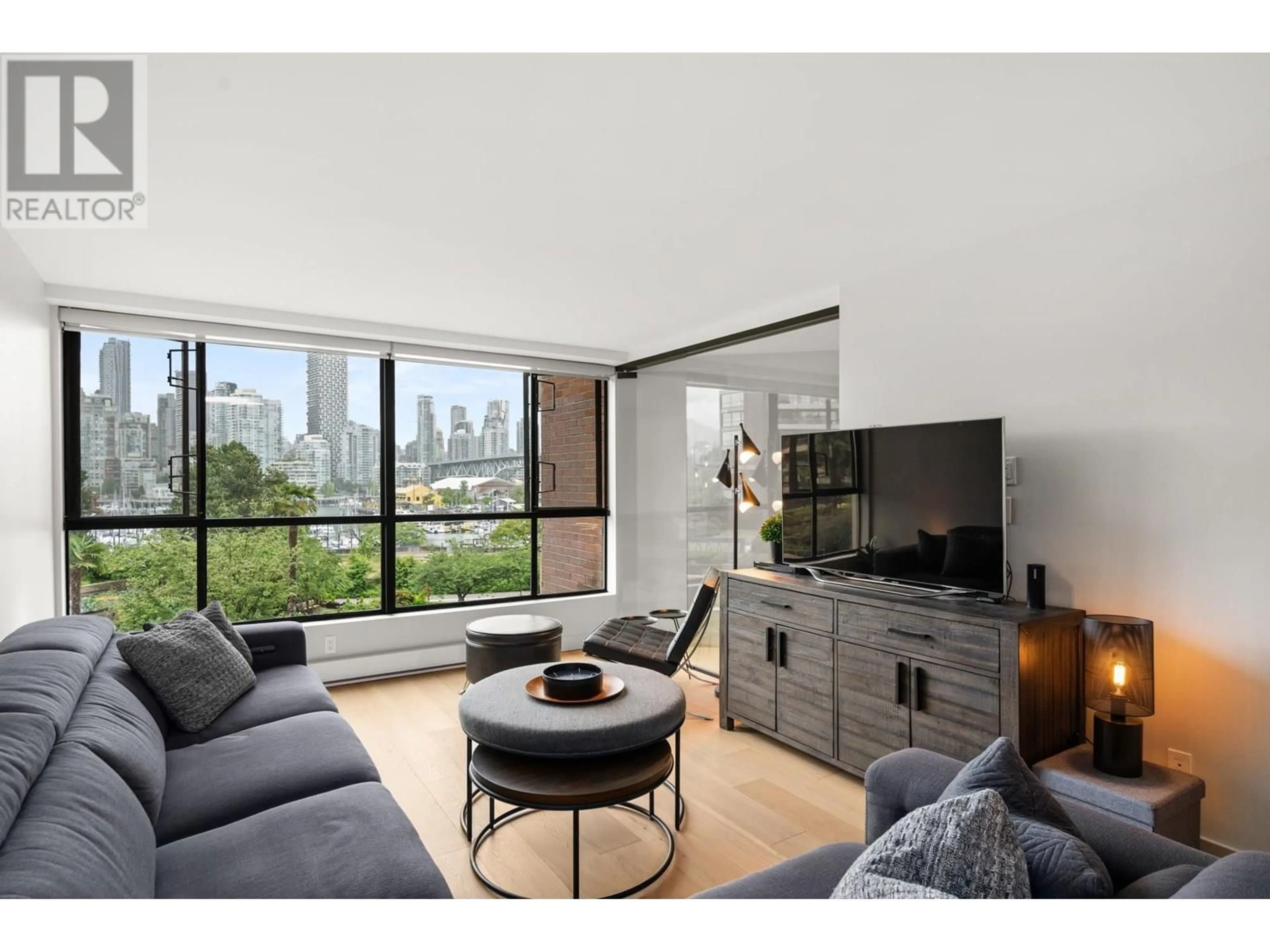 Living room with furniture, wood/laminate floor for 309 - 1490 PENNYFARTHING DRIVE, Vancouver British Columbia V6J4Z3