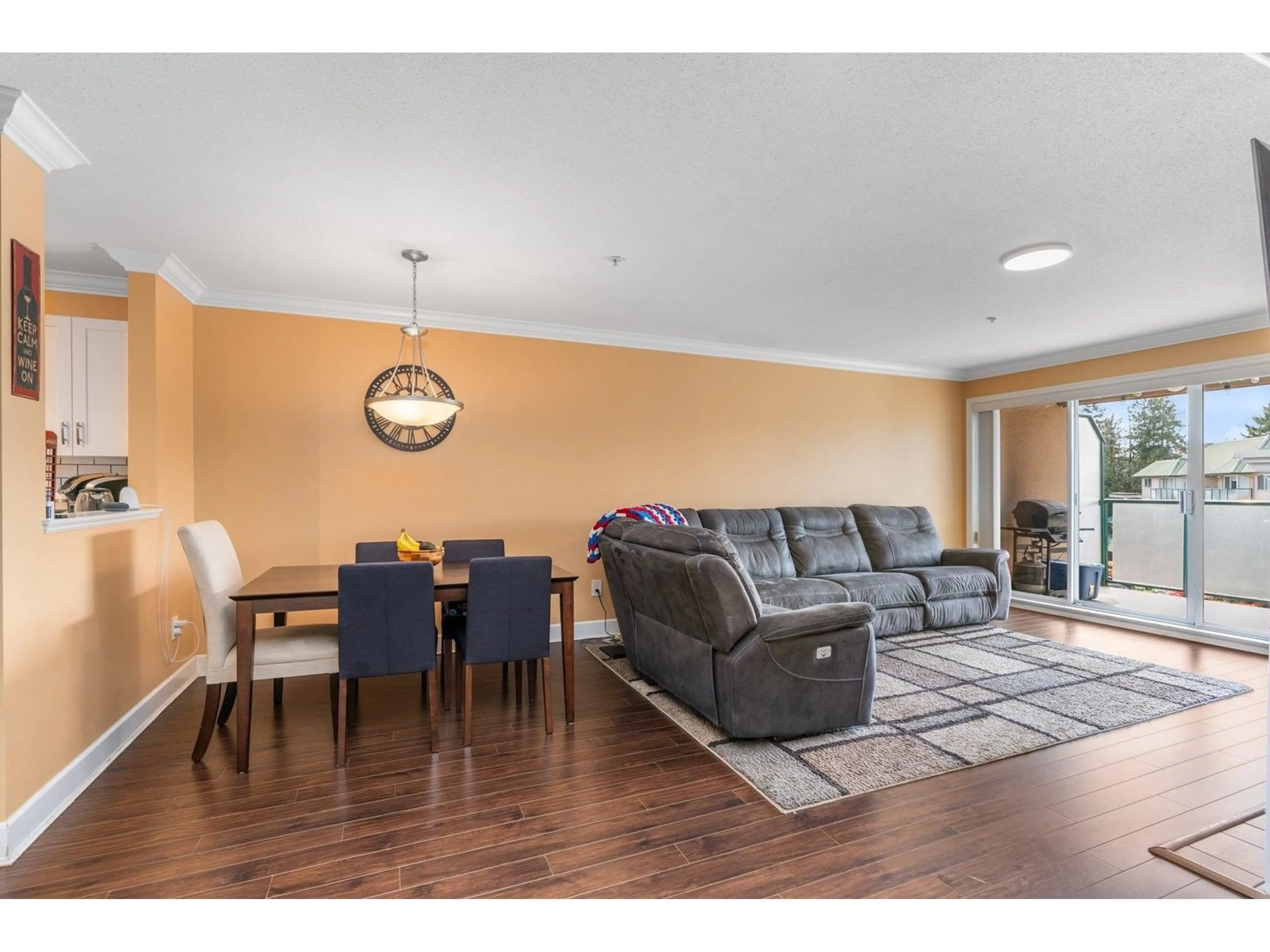 Living room with furniture, wood/laminate floor for 402 - 2962 TRETHEWEY, Abbotsford British Columbia V2T4M3