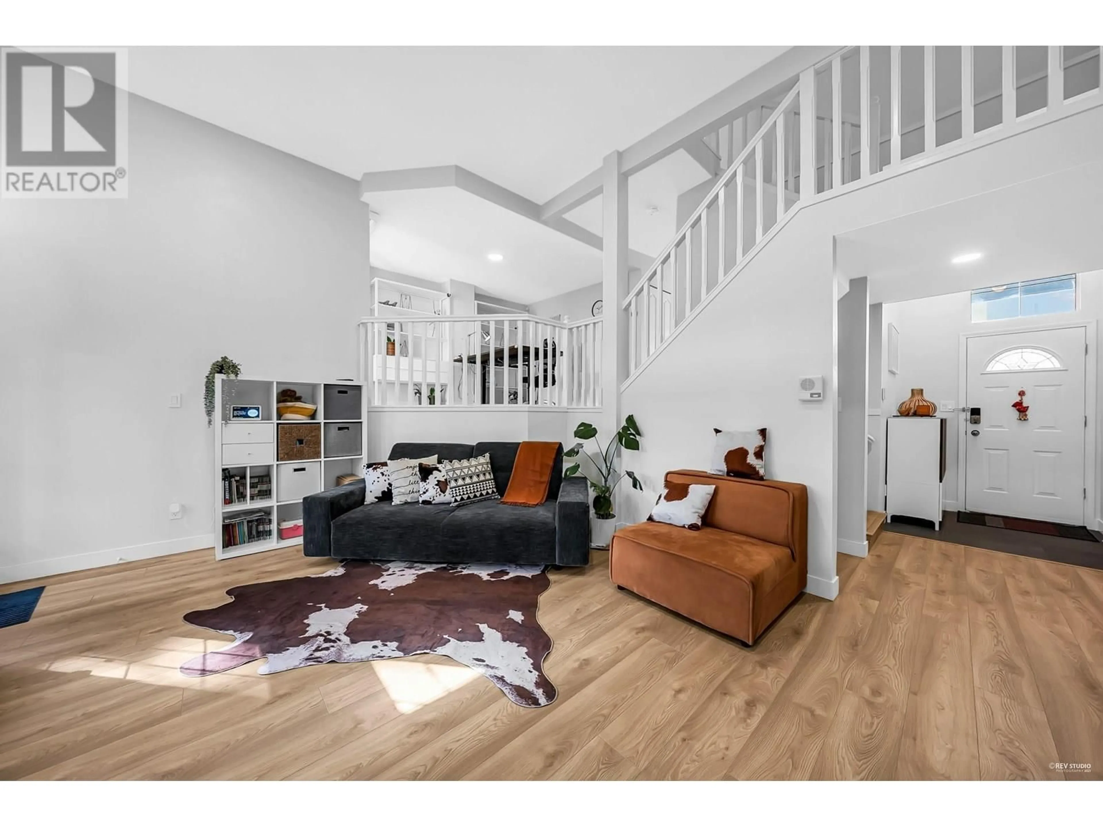 Living room with furniture, wood/laminate floor for 257 WATERLEIGH DRIVE, Vancouver British Columbia V5X4T2