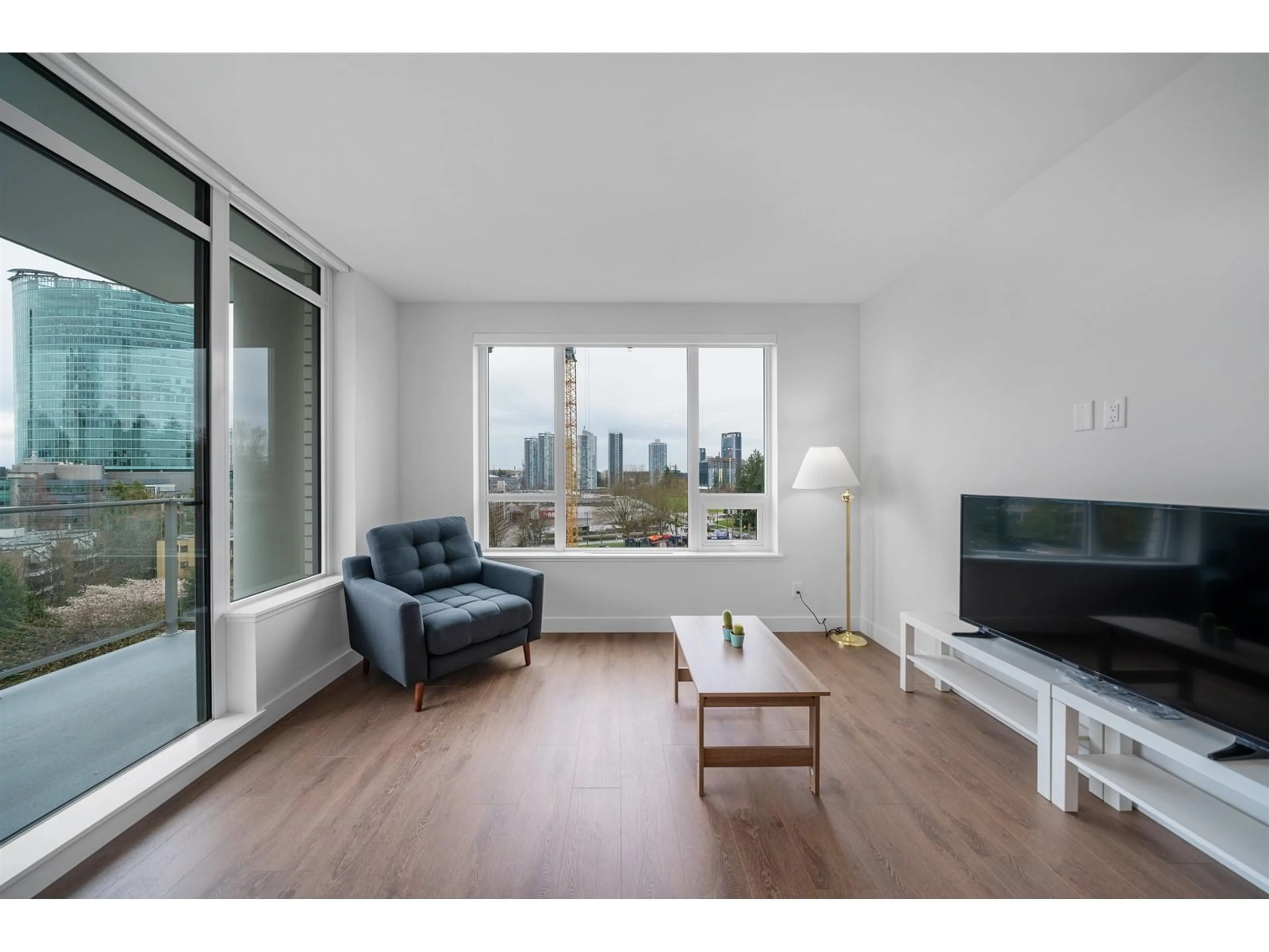 Living room with furniture, wood/laminate floor for 402 - 13359 OLD YALE, Surrey British Columbia V3T0S4