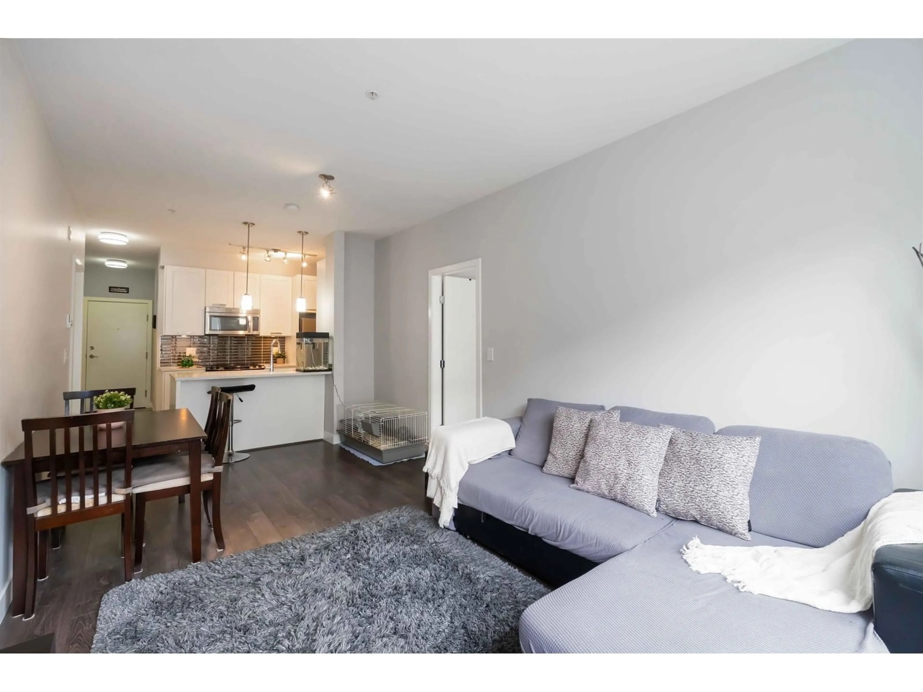 Living room with furniture, wood/laminate floor for 208 - 10455 154, Surrey British Columbia V3R0C5