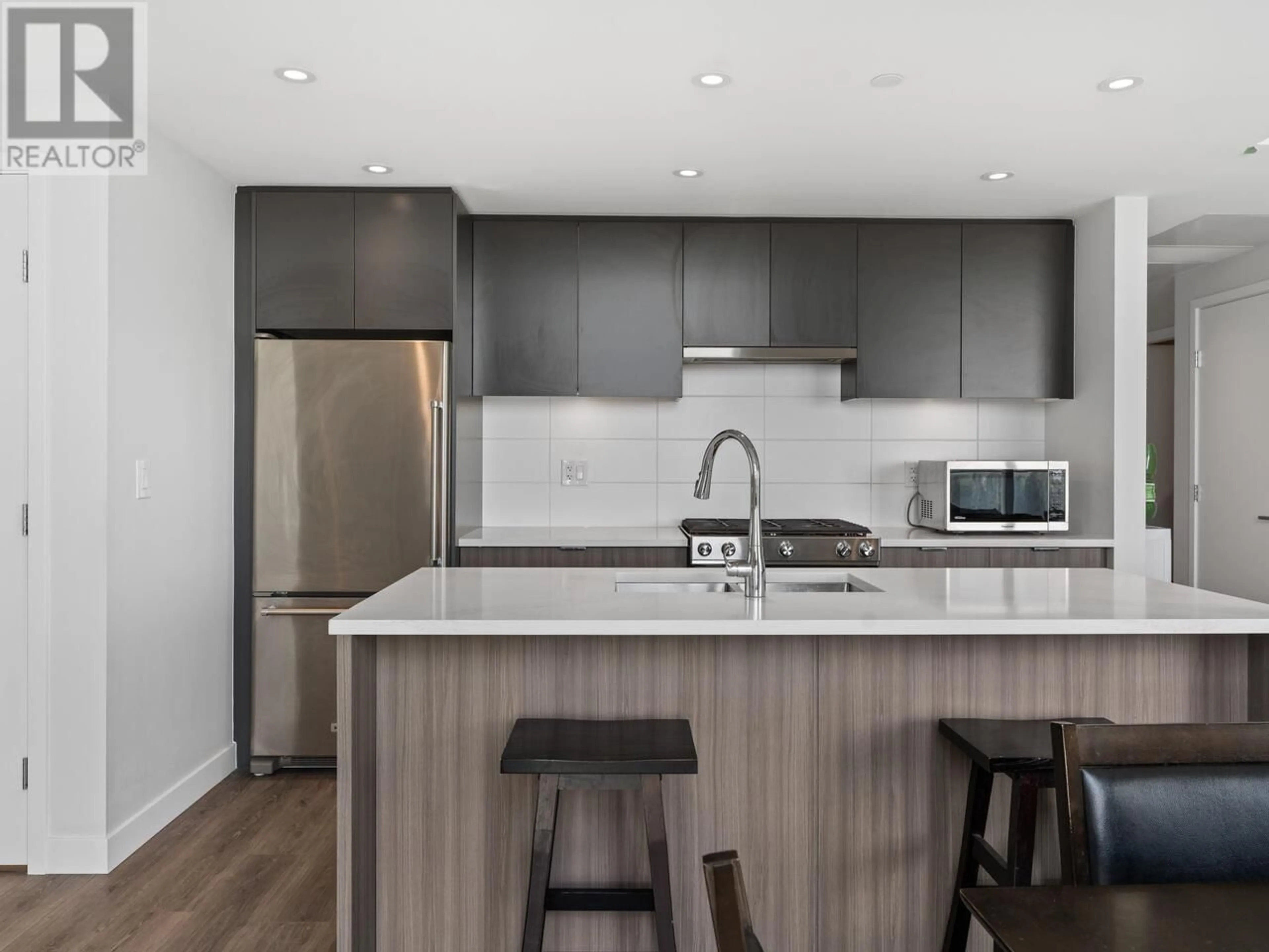 Open concept kitchen, wood/laminate floor for 1501 - 3430 KENT AVENUE, Vancouver British Columbia V5S0G7
