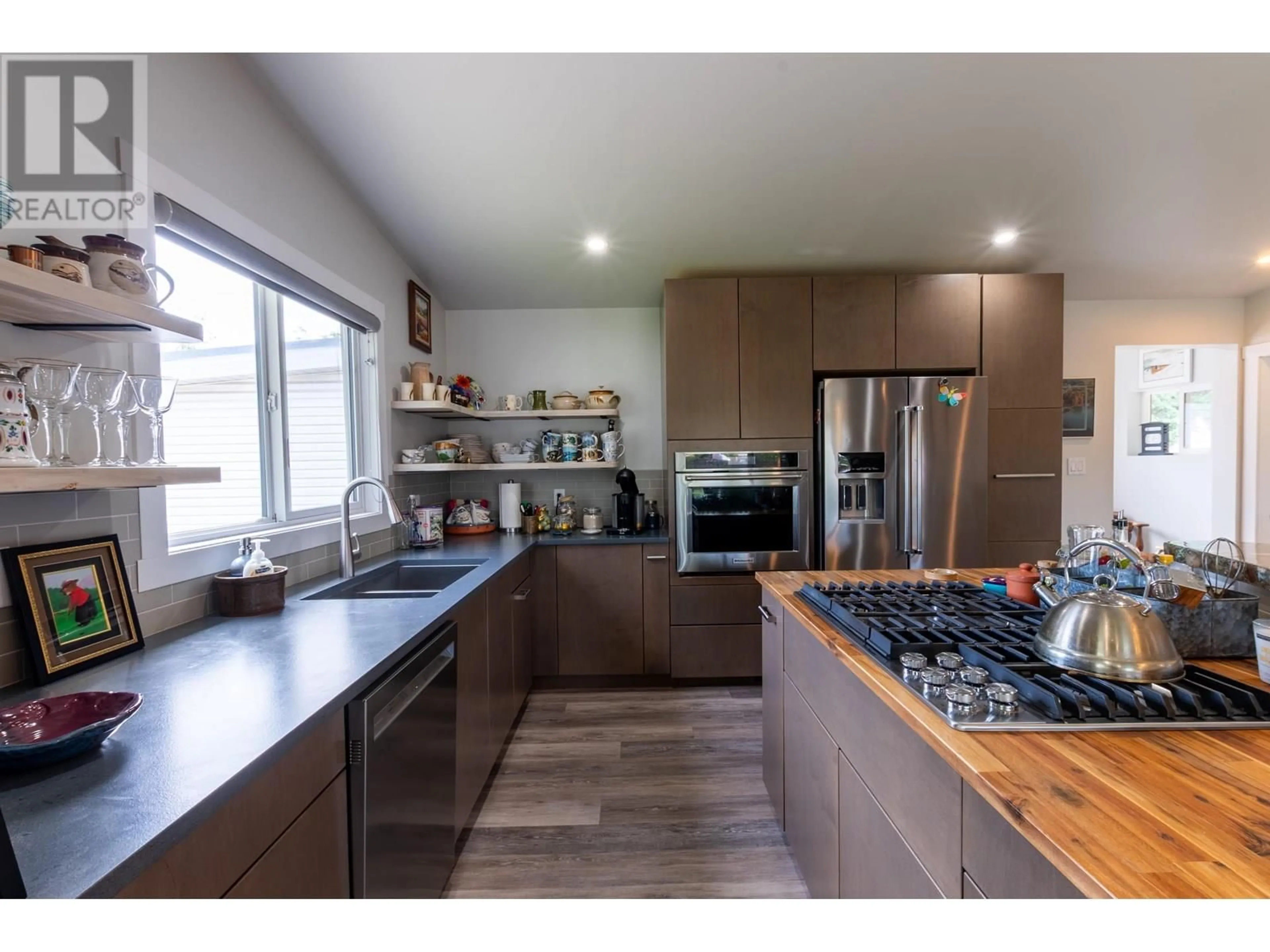 Open concept kitchen, wood/laminate floor for 305 KELLY STREET, Prince George British Columbia V2M3K4