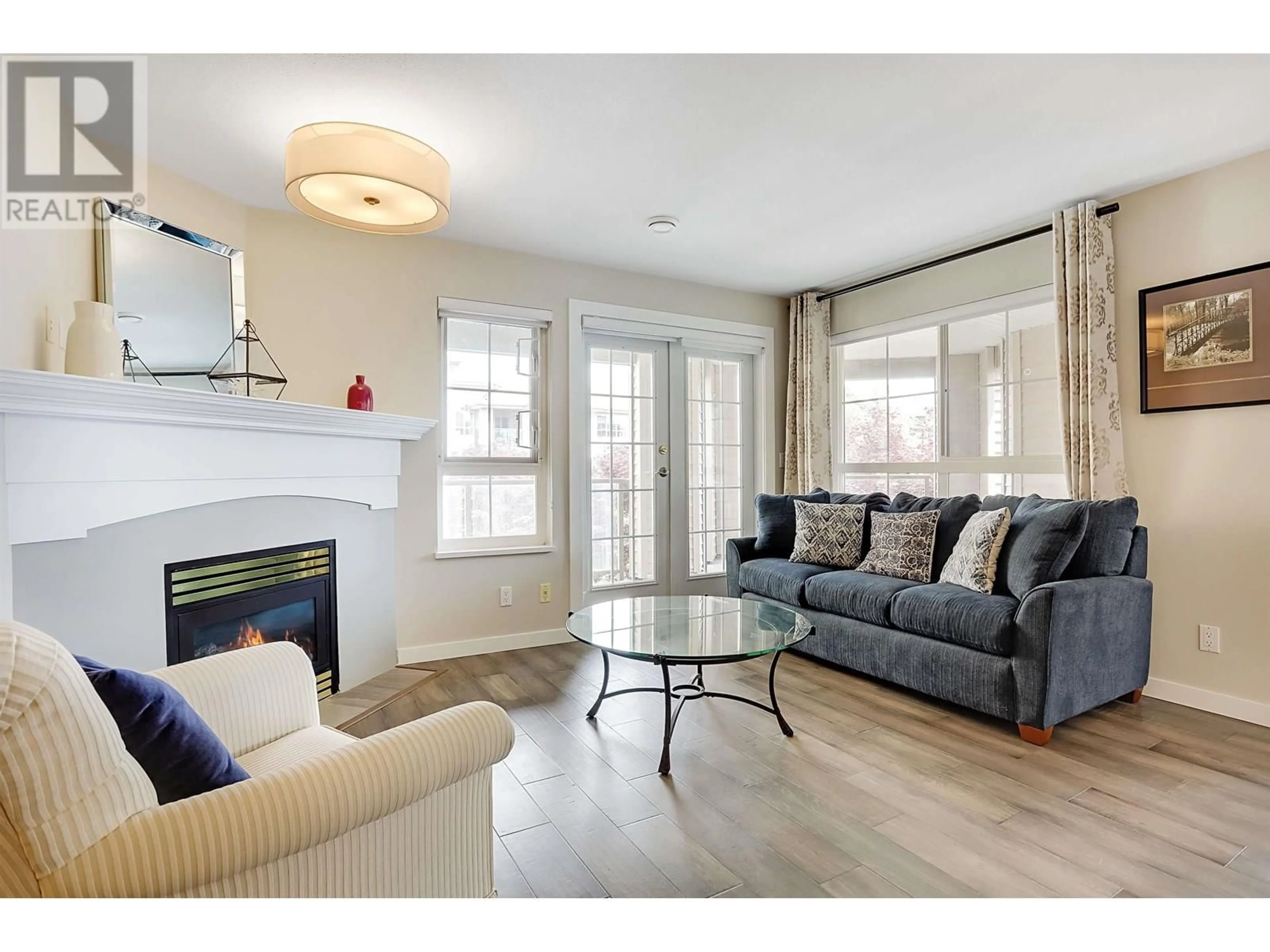 Living room with furniture, wood/laminate floor for 313 - 5500 ANDREWS ROAD, Richmond British Columbia V7E6M9