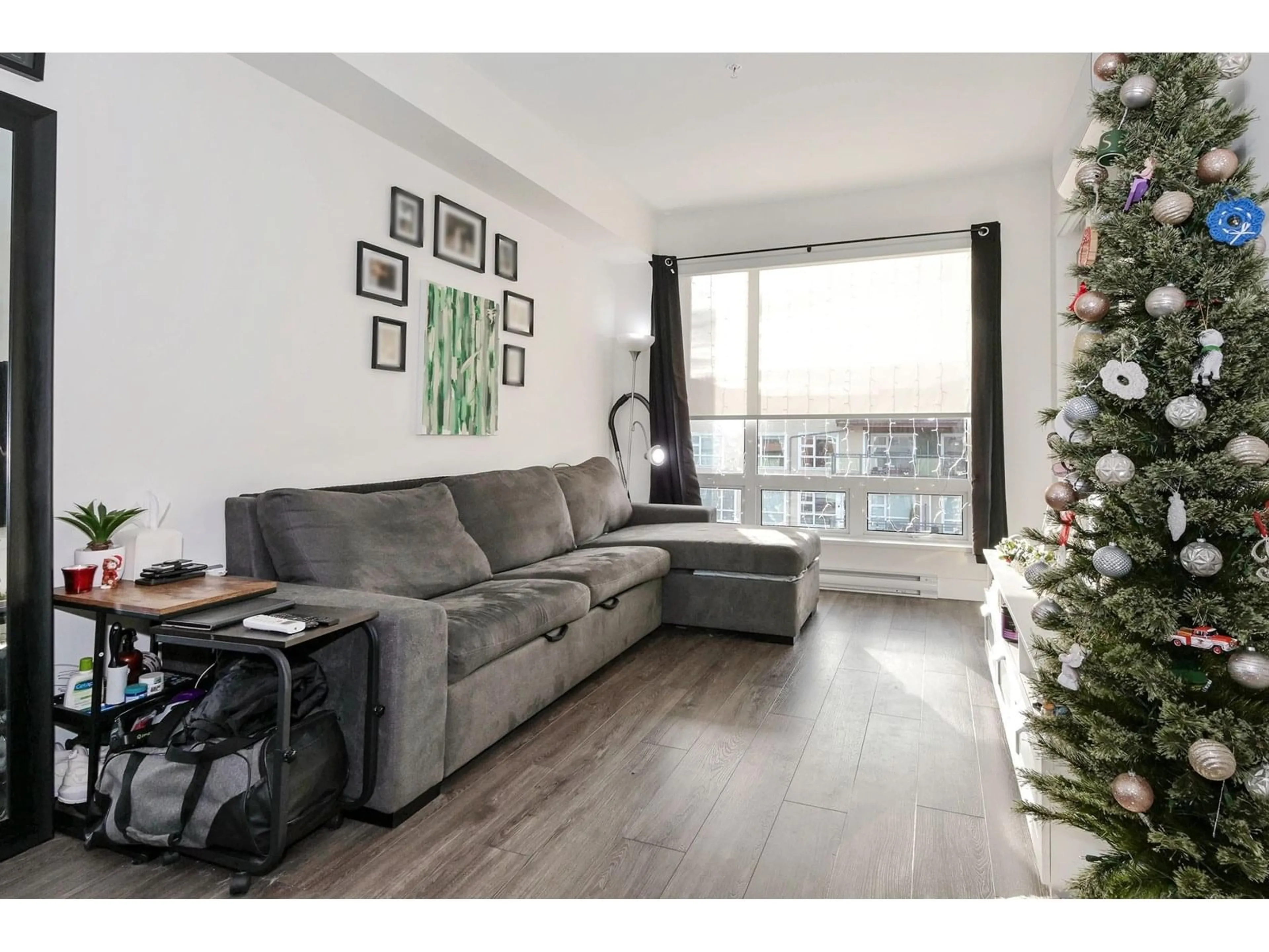 Living room with furniture, wood/laminate floor for A414 - 20727 WILLOUGHBY TOWN CENTRE, Langley British Columbia V2Y3N1