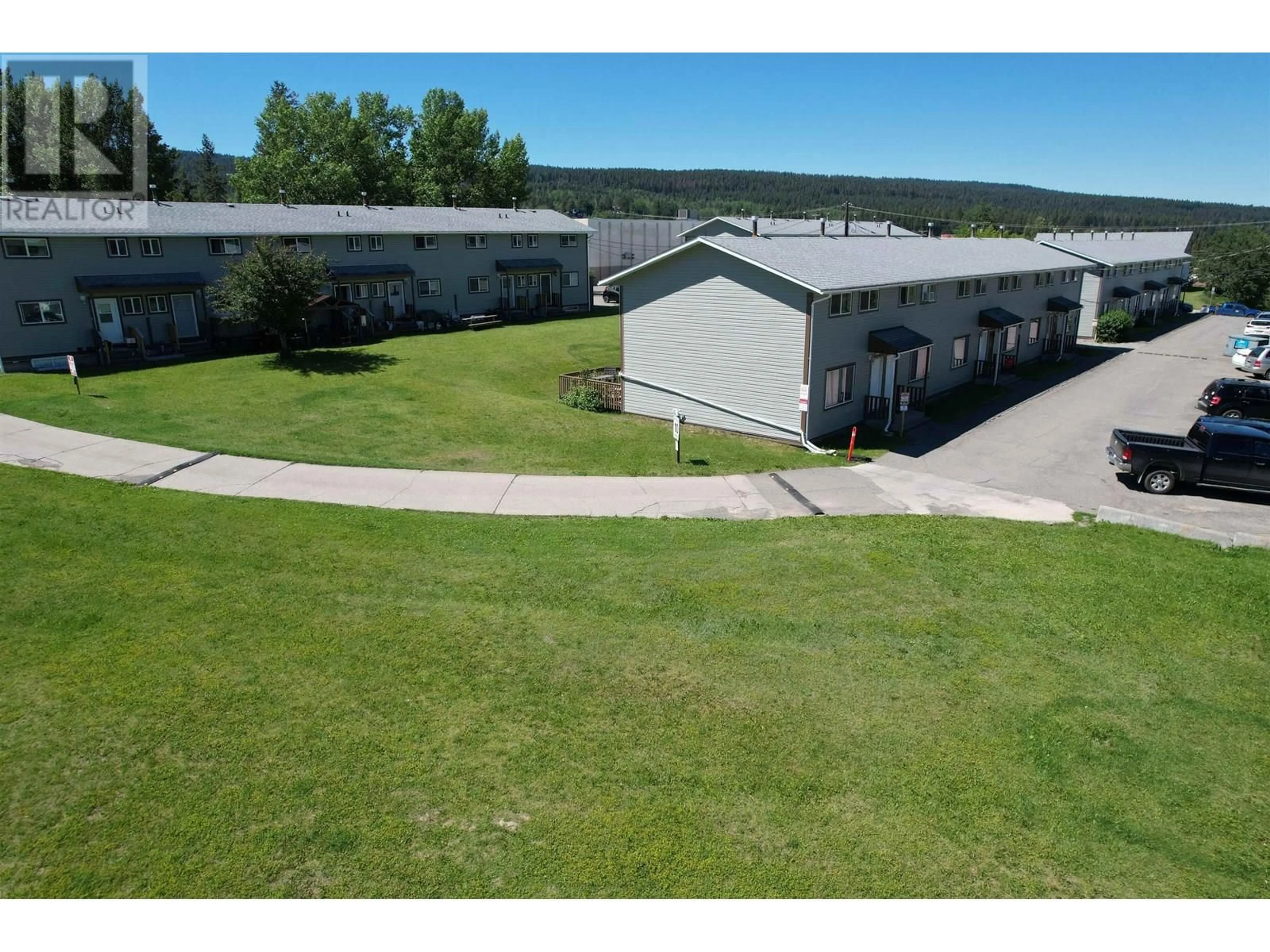 A pic from outside/outdoor area/front of a property/back of a property/a pic from drone, building for 2 - 565D BIRCH AVENUE, 100 Mile House British Columbia V0K2E0