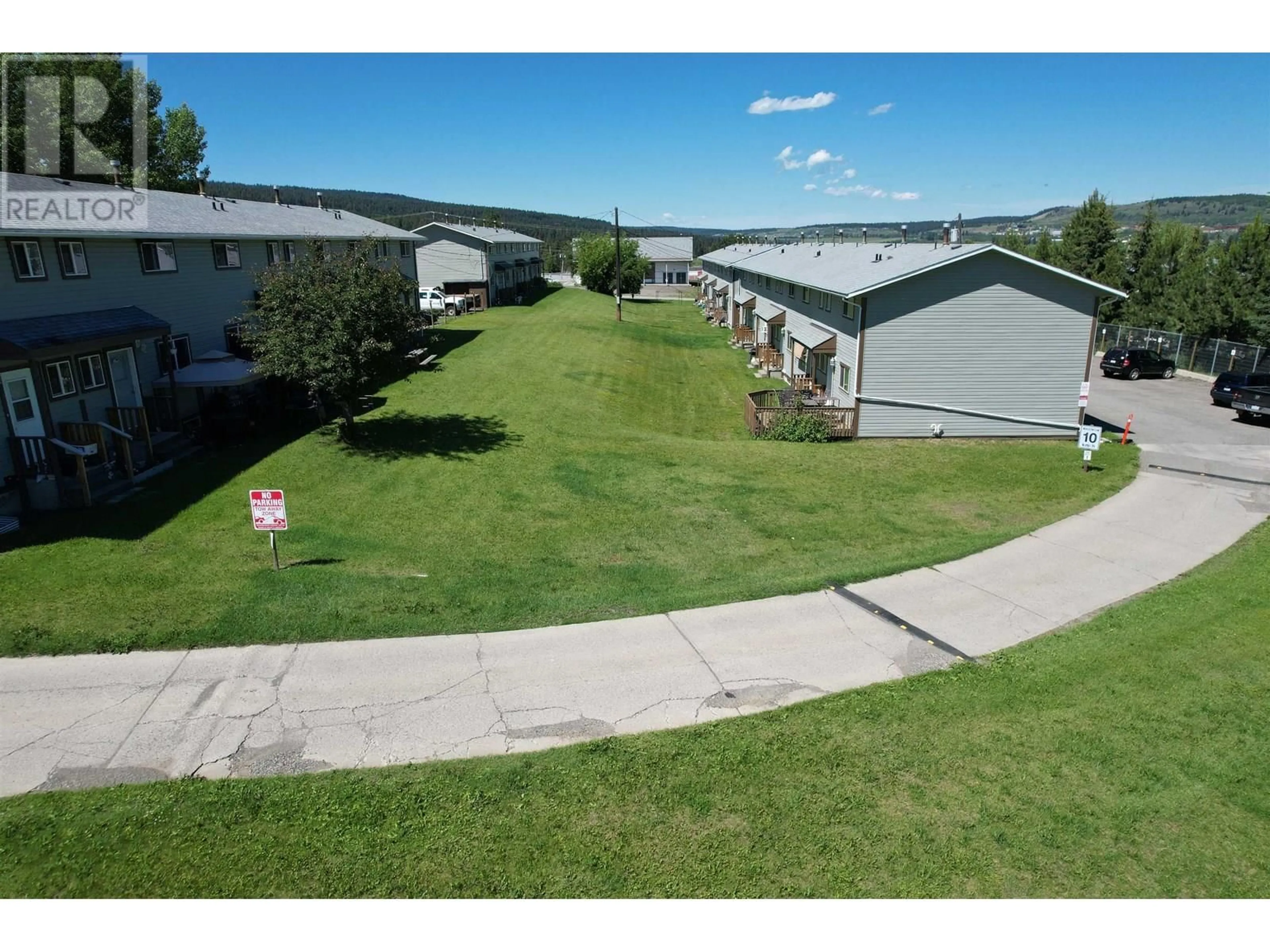 A pic from outside/outdoor area/front of a property/back of a property/a pic from drone, mountain view for 2 - 565D BIRCH AVENUE, 100 Mile House British Columbia V0K2E0