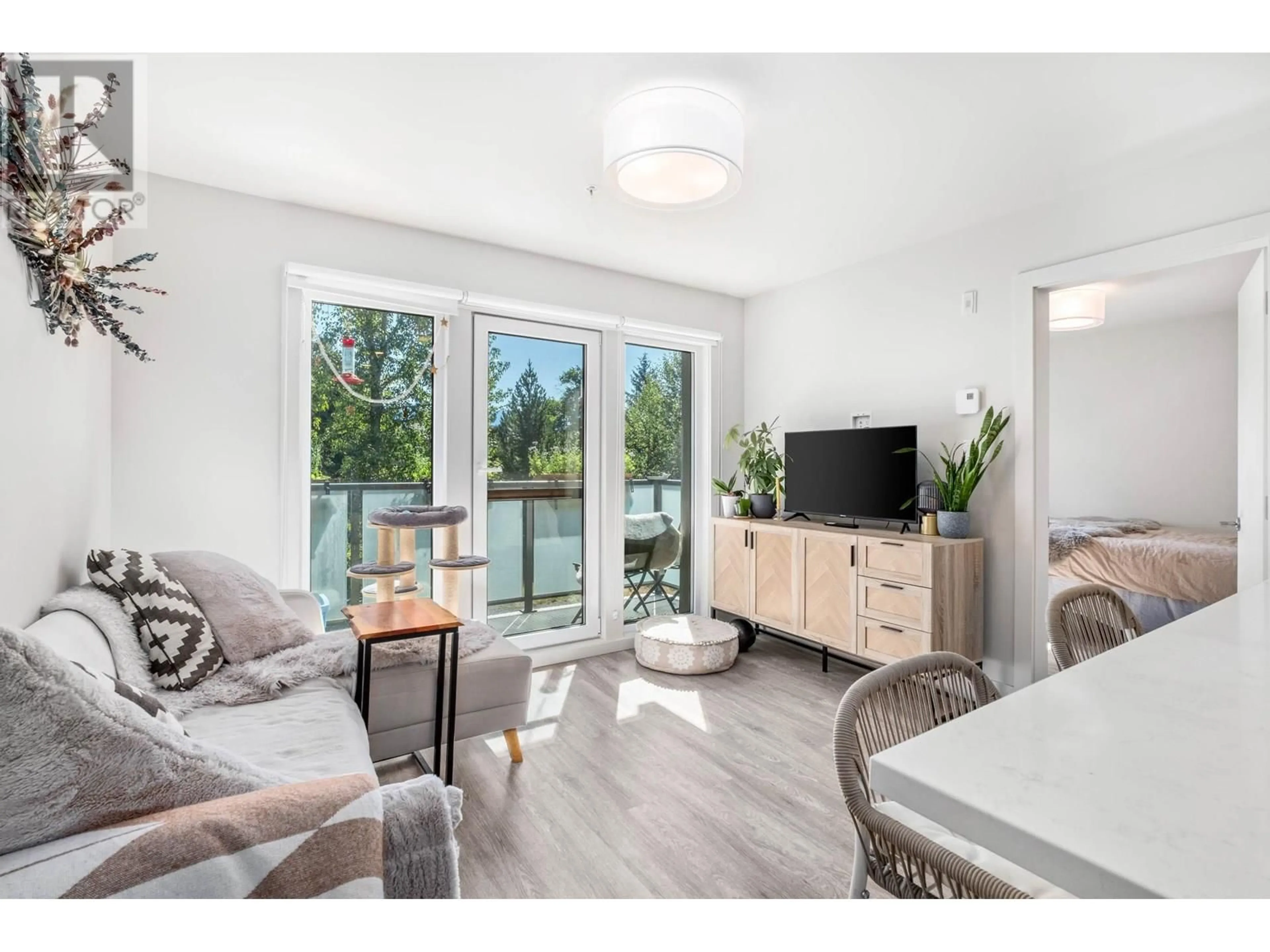 Living room with furniture, wood/laminate floor for 113 - 7350 CRABAPPLE COURT, Pemberton British Columbia V0N2L1