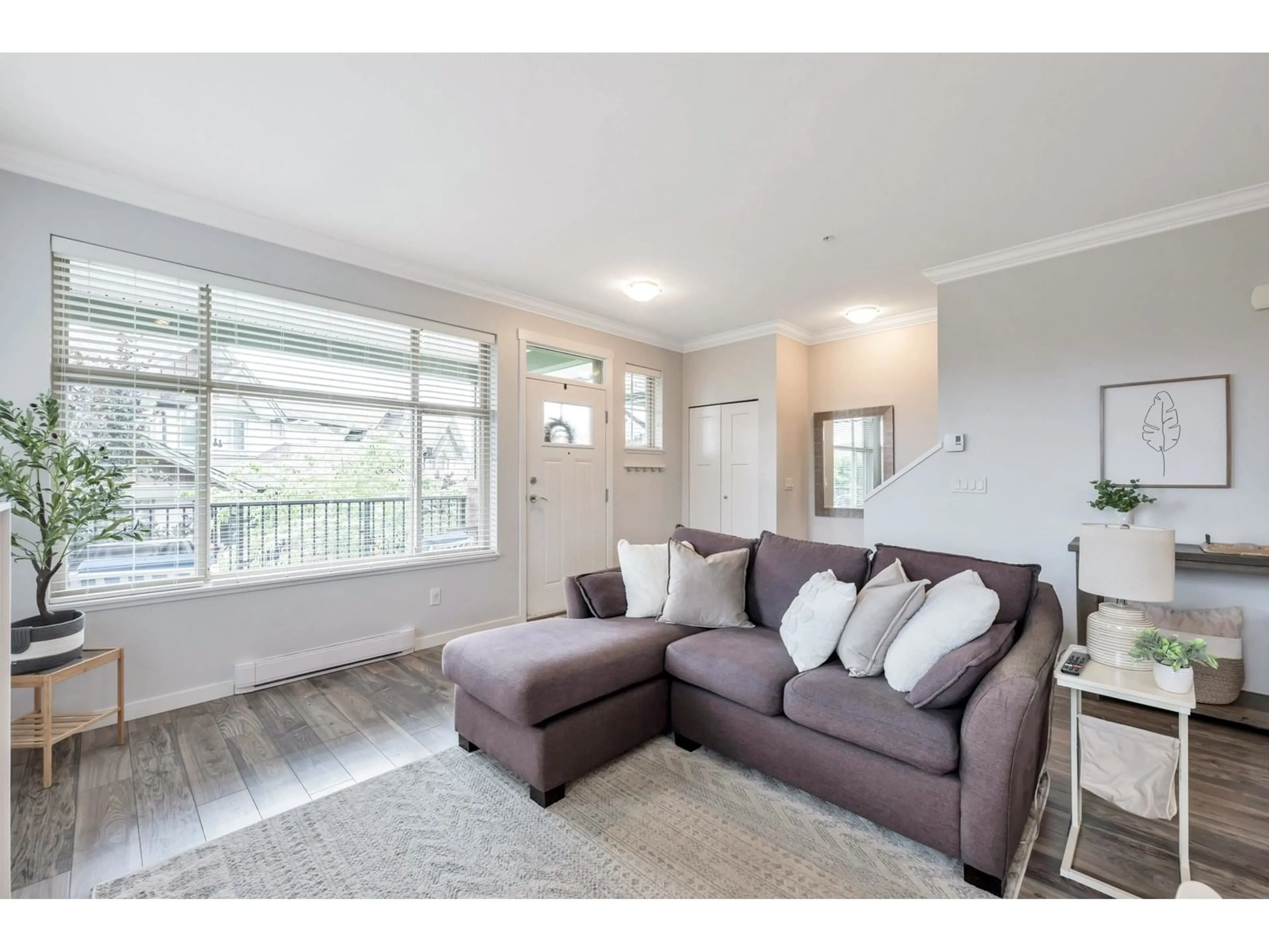 Living room with furniture, wood/laminate floor for 205 - 6706 192 STREET, Surrey British Columbia V4N6M9
