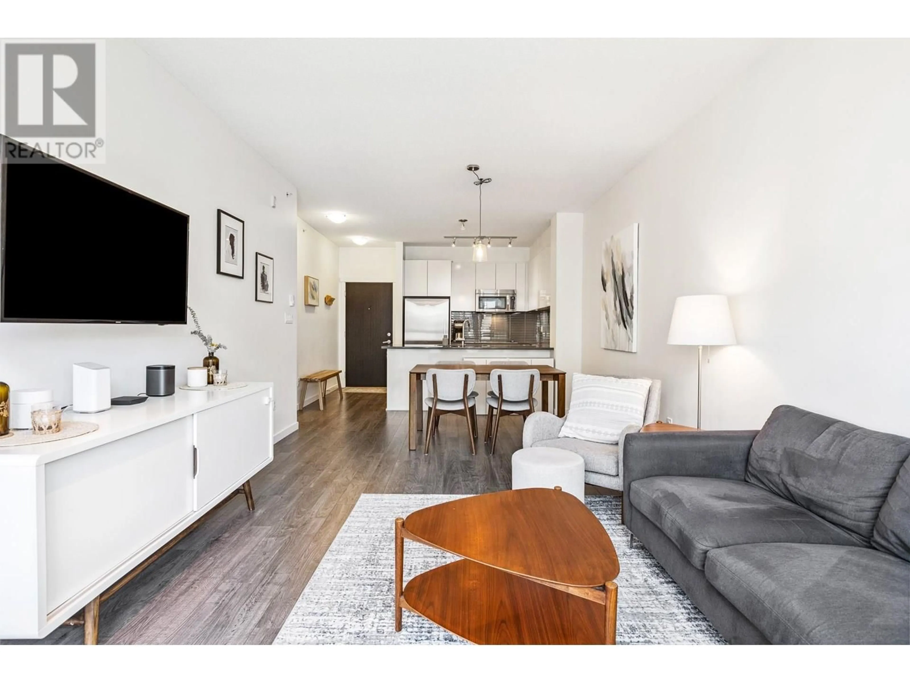 Living room with furniture, wood/laminate floor for 516 - 2665 MOUNTAIN HIGHWAY, North Vancouver British Columbia V7J0A8